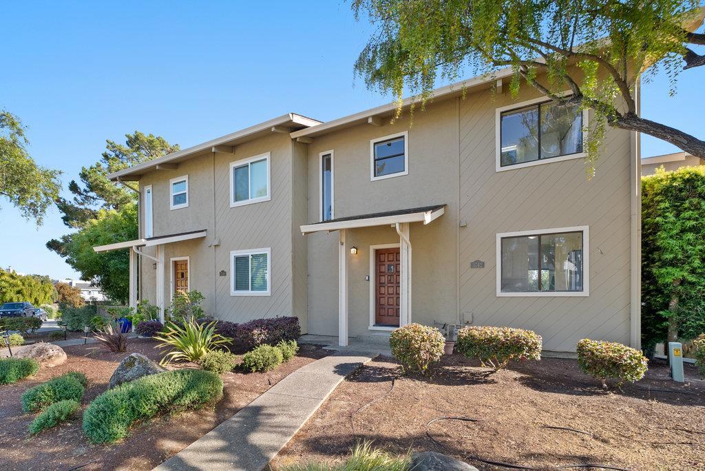 Nestled in the serene Seascape neighborhood of Aptos, 1742 Seascape Blvd offers a spacious 2-bedroom, 2.5-bath townhouse with 1,692 sq ft of living space. Built in 1983, this modern-style home features soaring ceilings with redwood accents, creating an open and airy atmosphere. The formal dining room boasts refinished parquet floors and opens to a private deck, perfect for al fresco dining. The living room is ideal for entertaining, complete with a convenient wet bar and a gas log fireplace. Large windows and sliders throughout the home provide abundant natural light and offer serene views of the surrounding trees and distant ocean peeks. Both spacious bedrooms share a deck, enhancing the home's indoor-outdoor flow. Additional highlights include ample closet space, a bonus closet in the upper hall, and a two-car garage with a large laundry room that offers potential for a hobby center or extra storage. Located just down the street from beach paths, shops, and dining, this townhouse combines comfort and convenience in a desirable coastal setting.