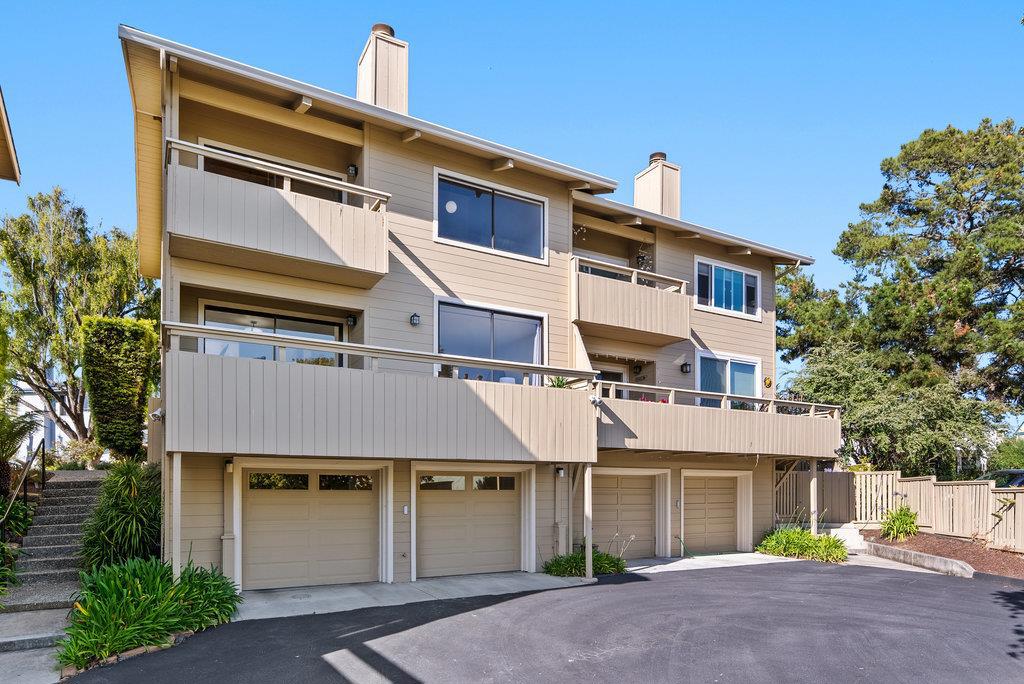 Nestled in the serene Seascape neighborhood of Aptos, 1742 Seascape Blvd offers a spacious 2-bedroom, 2.5-bath townhouse with 1,692 sq ft of living space. Built in 1983, this modern-style home features soaring ceilings with redwood accents, creating an open and airy atmosphere. The formal dining room boasts refinished parquet floors and opens to a private deck, perfect for al fresco dining. The living room is ideal for entertaining, complete with a convenient wet bar and a gas log fireplace. Large windows and sliders throughout the home provide abundant natural light and offer serene views of the surrounding trees and distant ocean peeks. Both spacious bedrooms share a deck, enhancing the home's indoor-outdoor flow. Additional highlights include ample closet space, a bonus closet in the upper hall, and a two-car garage with a large laundry room that offers potential for a hobby center or extra storage. Located just down the street from beach paths, shops, and dining, this townhouse combines comfort and convenience in a desirable coastal setting.
