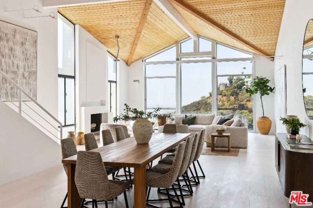 Experience contemporary luxury in this newly updated Bel-Air residence, perfectly positioned on nearly half an acre in one of Los Angeles' most prestigious neighborhoods. The entry level showcases soaring warm wood ceilings, dramatic architectural rooflines, and walls of glass framing sweeping views of the ocean, city, and canyon. Designed for both comfort and entertaining, this floor offers a light-filled living room with fireplace, a formal dining area, gourmet kitchen with adjoining laundry room, two bedrooms (one en suite), and a powder room. Up the staircase from the entry, the entire second floor is devoted to the primary suite, a private sanctuary with spacious bedroom, walk-in closet, and a spa-like bath. Indulge in the cedar-planked sauna, sleek shower, or freestanding tub while taking in panoramic views of downtown Los Angeles. Downstairs from the entry, the lower level is designed for relaxation and entertainment. A lounge with wet bar opens to a private outdoor deck overlooking the canyon, shielded by tall hedges for seclusion. This level also features an additional bedroom and large bonus room, ideal for guests, a home office, or wellness space. Just minutes from Bel-Air Country Club, Hotel Bel-Air, and the world-class shopping and dining of Beverly Hills, this move-in-ready property blends modern design, privacy, and convenience in one of Los Angeles' most coveted settings.