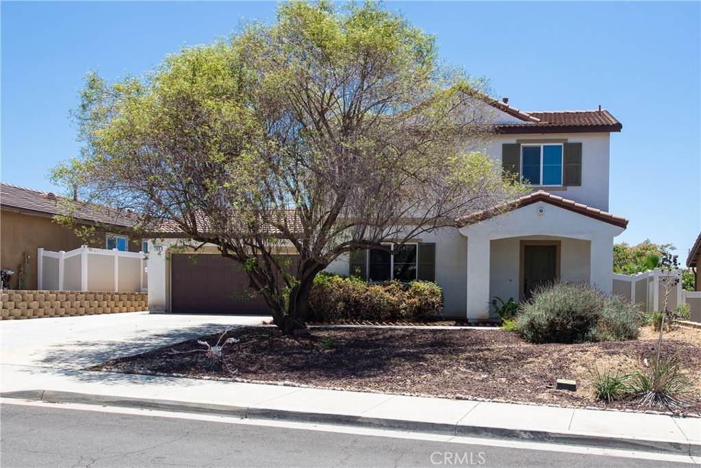 Welcome to this TURNKEY 3 bed, 2.5 bath home situated on an oversized flat, fully usable 7840 sq. ft. lot. Designed with efficiency in mind, this home features drought-tolerant landscaping, a tankless water heater, and a prepaid PPA solar plan—providing both eco-conscious living and cost savings. Step through the foyer into a light-filled living room with large windows, a ceiling fan and gorgeous light brown, wood-like tile flooring. The spacious kitchen is located at the back of the home boasting rich dark brown cabinetry with convenient pull-out drawers, striking granite countertops with a glass tile backsplash, a black granite sink, and a pantry for plenty of storage. A water filtration system under the sink ensures clean drinking water anytime. The attached dining area is perfect for quick meals and entertaining alike. Upstairs, all three bedrooms are thoughtfully laid out. The roomy primary suite overlooks the backyard and features an ensuite bathroom with dual sinks, a soaking tub, separate shower, with a large walk-in closet. The two secondary bedrooms are located at the front of the home offer mirrored closet doors and plenty of natural light with their large windows. Down the hall is a full bath with bathtub/shower combo and a conveniently located laundry area which completes the upper level. Step outside through the French door onto the covered patio, while enjoying views of the private backyard with no rear neighbors, ideal for relaxing or entertaining. The backyard features artificial turf, various berry bushes, a grape vine and multiple planter boxes ready for your homegrown vegetables centered around the pergola in the center of the yard. The long expanded driveway leads to the fully insulated 2-car garage providing ample cabinetry for storage. Great location… just minutes from freeways, shopping, dining, schools and parks. This is a rare opportunity to own a move-in-ready home with space, efficiency, and privacy—schedule your showing today!