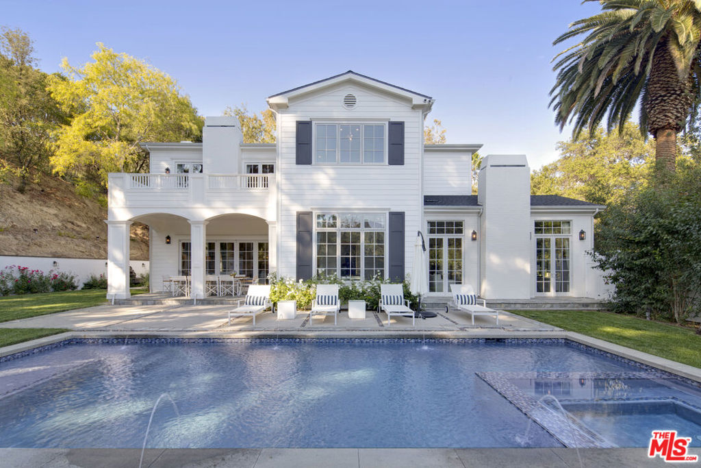 Nestled on a serene knoll with sweeping canyon views, this extraordinary estate offers a rare blend of privacy, luxury, and timeless elegance. Built from the ground up in 2015, this 6-bedroom, 8-bathroom masterpiece spans over 6,400 square feet of refined living space, ensuring comfort and sophistication at every turn. Located in the highly sought-after Royal Oaks area, the home is walled and gated for ultimate privacy. The open floor plan features French doors throughout, with pocket doors in the great room, seamlessly blending indoor and outdoor living. The elegant formal living room and dining room, which includes a temperature-controlled wine room, provide a perfect setting for entertaining. The state-of-the-art chef's kitchen is a true culinary haven, featuring two center islands, luxurious Calacatta marble countertops, top-of-the-line appliances, a butler's pantry, walk-in pantry, and an adjoining breakfast area. The second level offers a home theater and a private office for work or study. The primary suite is a true retreat, complete with a spa-like bath, dual walk-in closets, and a large balcony overlooking the picturesque surroundings. Step outside to a resort-style backyard, complete with a sparkling pool and spa, a cozy sitting area with a firepit, a covered loggia, BBQ pavilion, and two grassy areas ideal for relaxation or play. This exceptional estate offers the perfect combination of luxury, comfort, and privacy in one of the most desirable neighborhoods.