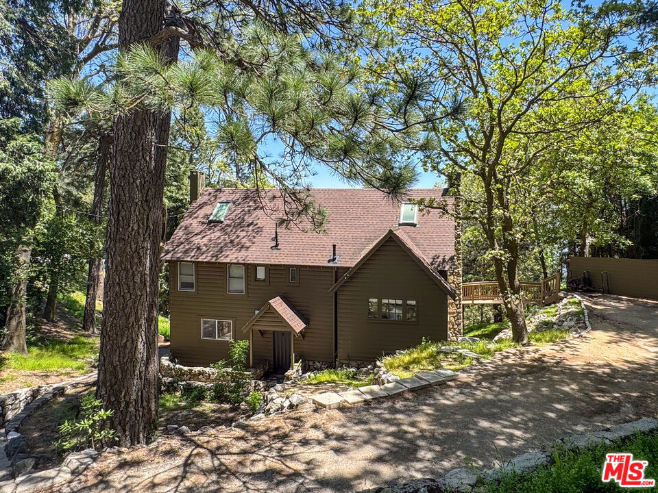 1930's Crestline/Lake Gregory Vintage Cabin with awe inspiring Mountain Views! Step into this dreamy remodeled cabin, reimagined as a designer-perfect, magazine-worthy retreat with panoramic views of the breathtaking San Bernardino Mountains. Nestled among towering pines and beneath star-filled skies, this dreamy home is a true Crestline treasure just minutes to fishing and boating in beautiful Lake Gregory and under two hours from Los Angeles. Located in the charming mountain community of Cresetline, only 15 minutes from Lake Arrowhead, this home offers the perfect escape for anyone craving peace, nature, and small-town lake living. Inside, a stunning chef's kitchen has been beautifully remodeled and opens to jaw-dropping mountain vistasideal for entertaining or simply enjoying your morning coffee. The expansive "Yellowstone"-style living room features a dramatic stone fireplace, creating a cozy and spacious gathering place for family and friends.The home includes remodeled bathrooms, two large decks for al fresco dining, and an incredible unfinished basement with potential for additional bedrooms or a custom common area. A detached two-car garage includes a studio space above perfect for a creative retreat, office, or guest area. There's even room to park an RV. Whether you're a weekend warrior or looking for a full-time mountain and lake escape, this peaceful mountain retreat offers starry nights, fresh air, and small-town charm. Easy to show, easier to fall in love with.