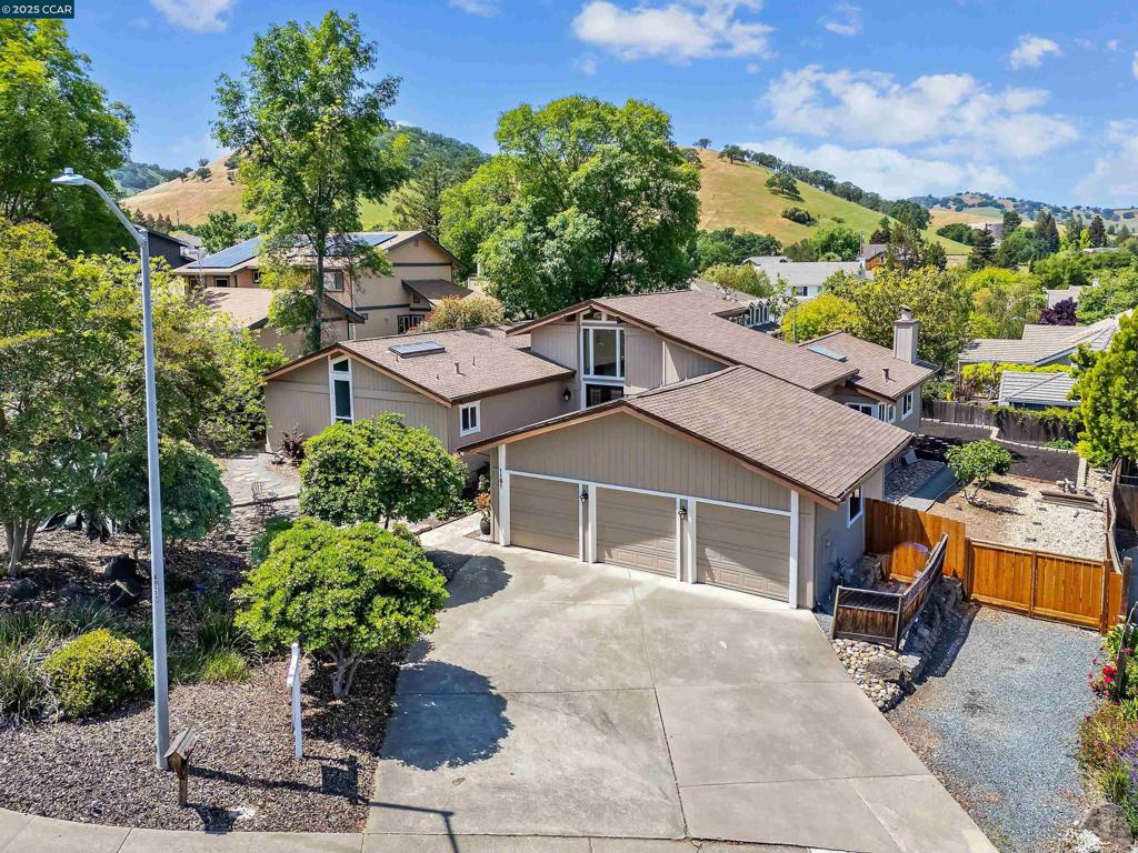 Enjoy serene hill views from this light-filled, thoughtfully updated contemporary single-story home. Mt Diablo schools with Northgate High as a possibility. Renovated in 2020, the spacious kitchen features modern cherry tundra cabinetry with full-extension drawers, quartz countertops, and high-end appliances including a 48" Bertazzoni five-burner gas range, Bosch dishwasher, GE microwave, and Samsung refrigerator. Additional upgrades include dual-pane Milgard windows, ¾" select maple hardwood flooring, and new carpet in the living room and primary bedroom. The spacious primary suite is designed for comfort and privacy, complete with a walk-in closet, a second closet for extra storage, and direct access to a private deck with a hot tub. The luxurious en suite bath includes a pedestal tub, granite counters, dual sinks, and a separate shower area. Two additional bedrooms share a convenient Jack-and-Jill bathroom, while a dedicated office/studio provides an ideal work-from-home setup. The side yard offers potential for a garden or a sport court, adding to the home’s versatility. This beautifully updated home is move-in ready and waiting for its next chapter.