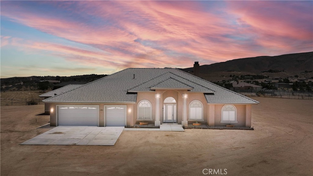 Welcome to 21777 Poppy Road — A Stunning Apple Valley Retreat! This gorgeous 3,348 sq ft estate in Mariana Ranchos sits on over 2 fully fenced acres with panoramic views, vaulted ceilings, and natural light in every room. The updated chef’s kitchen is a dream with Viking Professional appliances, a 6-burner stove, huge walk-in pantry, and breakfast bar seating for six. A formal dining room and cozy breakfast nook offer plenty of space to gather and entertain. The spacious living room features a custom stone fireplace, built-ins, and pre-wired surround sound. The luxurious primary suite includes a sitting area, spa-like bathroom with jetted tub, dual vanities, and an oversized walk-in shower. Two additional guest rooms (each with sitting areas) share a full bath, and the split floor plan offers comfort and privacy throughout. Outside, enjoy a covered patio, privacy fencing, and open space with room to add a pool, ADU, or toys. Ask to see the Virtual 360° Tour — it’s like walking through in real time!