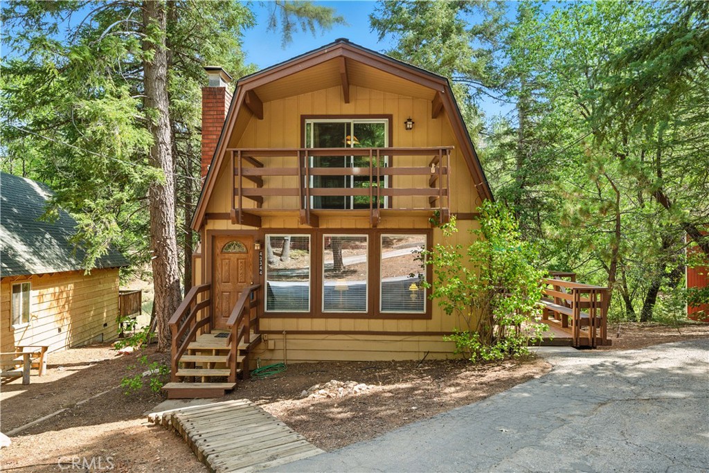 Welcome to this charming 2-story Moonridge cabin, perfectly nestled in the heart of Big Bear Lake! Featuring 3 bedrooms and 1 bathroom, this home sits on a spacious lot with endless potential for outdoor living and year-round enjoyment. Step inside to a cozy living room centered around a warm fireplace ideal for relaxing after a day on the slopes. The living area flows seamlessly into the dining room and kitchen, which has access to the outdoors for convenient entertaining. The main level offers a comfortable bedroom and full bathroom, while upstairs you’ll find two generously sized bedrooms, including one with sliding glass doors leading to a balcony perfect for soaking in the fresh mountain air. A large deck and ample parking add to the property’s practicality and appeal. Located in the desirable Moonridge area, this cabin places you minutes from Bear Mountain Ski Resort, Snow Summit, Big Bear Zoo, the golf course, Big Bear Lake, and the vibrant Village with its shops, restaurants, and nightlife. Whether you’re looking for a vacation getaway, investment opportunity, or year-round retreat, this property offers the perfect blend of comfort, charm, and location. Don’t miss your chance to own a piece of Big Bear living! Schedule your private showing today!