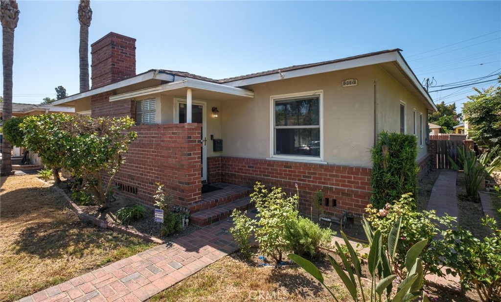 Welcome to 310 Forhan, a great house located in the Coolidge Triangle - one of the best neighborhoods in North Long Beach. This is a perfect starter home with two bedrooms, two bathrooms and a wonderful location within the neighborhood. The inviting open-concept layout features a large spacious living room with a cozy wood-burning fireplace, seamlessly flowing into the dining area and kitchen to create an expansive great room - perfect for entertaining or everyday living. The home boasts original hardwood flooring in both good-sized bedrooms, complemented by two remodeled bathrooms—one with a full tub and shower, the other with an easy walk-in full shower with rain head nozzle. Additional interior highlights include wood flooring throughout the main living spaces, copper plumbing, Nest-controlled heating and air conditioning, a security system, solar panels and double-pane windows in most rooms for enhanced energy efficiency and quiet. The exterior features a used brick patio in the rear, back gate for RV parking, a garden area, lemon tree, a two-car detached garage with alley access and a high-power outlet, ready for your plug-in car charger. All this plus a short walk to Coolidge park with basketball courts and picnic tables and convenient access to the 710 and 91 freeways, makes this the perfect place to call home!