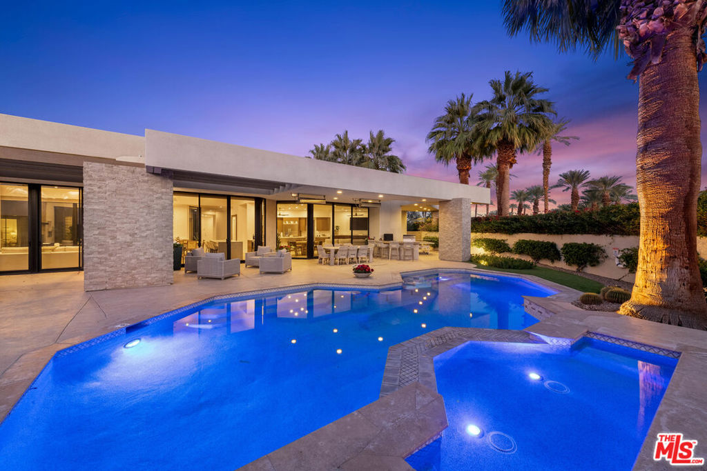 Welcome to paradise! Newly remodeled and just newly furnished custom 5 bed/5.5 bath Contemporary home located in the exclusive The Estancias gated community of only 49 custom properties in prime La Quinta location, close to Old Town, La Quinta Resort & some of the desert's finest world-class golf courses. Situated on a large 28,000+sf lot with private gated driveway, this home exudes the resort lifestyle with incredible indoor/outdoor flow, stunning modern designer finishes throughout and entertainer's backyard. Main home includes 3 bed/3.5 bath with detached 2 bed/2 bath casita (with fireplace, breakfast bar & fridge) located off of the home's inviting center interior courtyard featuring a beautiful spa and tranquil waterfall. Formal entry with powder room opens to spacious living room with entertainers bar & dining table for 10. Large family room opens to breakfast room & open chef's kitchen with quartz countertops, center island with waterfall edge & breakfast bar and walk-in pantry. Living room & family room all opening to relaxing beautifully landscaped backyard including covered patio with misting system, newer patio seating areas, fire pit, lounge chairs, built-in BBQ and Pizza oven and incredible over-sized sparking pool all overlooking beautiful mountain and sunset views. Primary suite has a separate wing off living room with fireplace, walk-in closet, gym that includes Peloton and spa-like primary bathroom with separate bath/shower. Additional features include porcelain wood-like tile throughout the home, 4-zoned ac/heat, newly installed 75" & 85" televisions and Sonos sound system throughout, ceiling fans in every room, all bedroom with ensuite bathroom and full-size laundry room with sink. Price may vary depending on month.