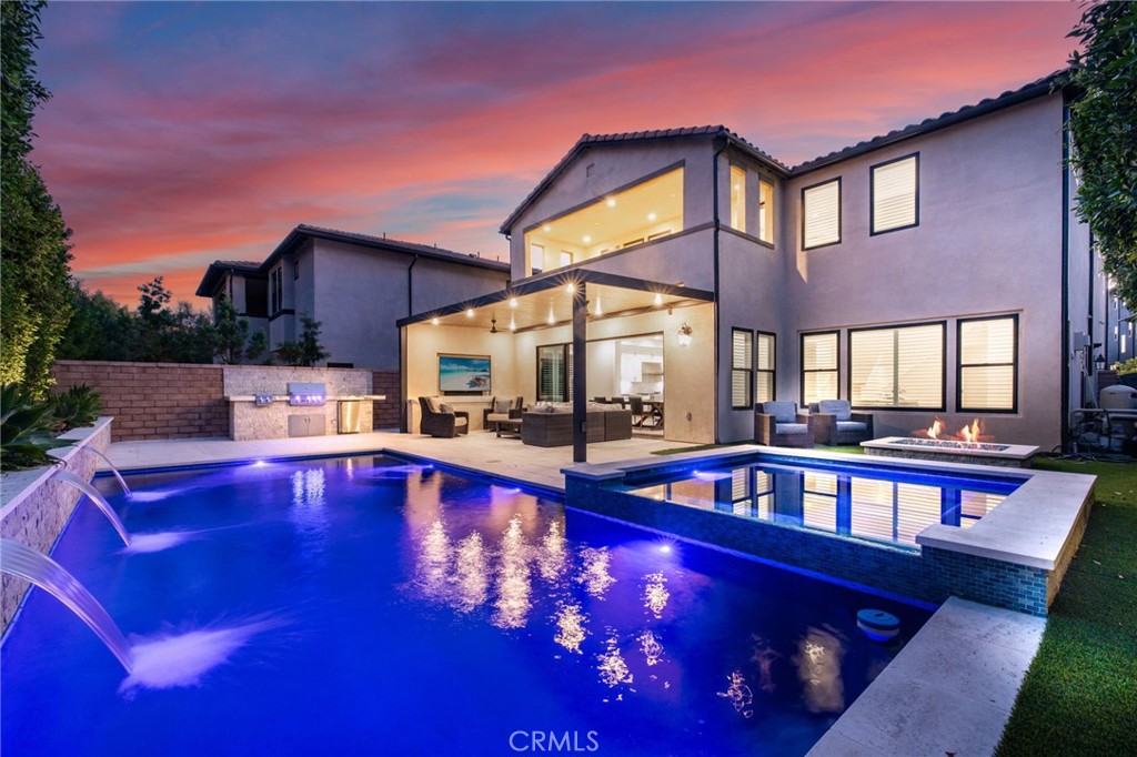 Incredible, One-Of-A-Kind Resort Style Pool Home, Fully Upgraded, Premium Lot Location, FULLY PAID FOR SOLAR! Sophistication and Elegance are the Hallmarks of this Impeccably Designed Home featuring Stunning Upgrades in every direction. Upon entry the Upgrades and On-Trend designs are immediately noticed with Stunning White Oak Harwood Floors that run through the entire home, Gorgeous Custom Feature Walls and Soaring Ceilings allowing for an abundance of Natural Light to flood the home. The Spacious Great Room features a Custom Fireplace and Modern Mantle, Plantation Shutters, Designer Interior Paint, and Sliding Panel Doors that open to the Award Winning Backyard Oasis. The Stunning Chef’s Kitchen leaves nothing to the imagination with Stainless Steel Appliances including Built-In Stainless Steel Refrigerator, Custom Designer RH Pendant Lighting, Dual Tone Upgraded Quartz Countertops, Custom Artisanal Tile Backsplash, Beautiful Upgraded White Cabinets that stretch to the ceiling, Spacious Walk-in Pantry and Massive Center Island w/Bar Seating. Continue Outside and Prepare to be blown away by THE ENTERTAINERS DREAM BACKYARD. The Covered California Room offers the perfect Transition to the Backyard featuring 2 Ceiling Fans, Entertainment Nook with TV and Beautiful Porcelain Slab Mantle. Just beyond the California room sits the Stunning Pool and Jacuzzi w/ Pentair IntelliCenter Pool Spa Automation, Exquisitely Designed w/Pebble Tech Sheen, Limestone Decking, Waterfalls & Custom Pool Lighting. The Outdoor Upgrades also Include a Modern Fire Pit, Tropical Mature Lush Landscape, Custom Hardscape, Artificial Turf, and Spectacular Built-In Bar w/ Custom Artisanal Stone Design & Porcelain Slab. Vacation every weekend in your own backyard! The Downstairs Spacious Bedroom and Full Bathroom round out the first floor. Upstairs you will find the Highly Desirable Multi-Purpose Loft/Media Room, The Convenient Upstairs Laundry and Four additional Bedrooms including the Spacious Primary Retreat. Start Your New Wellness routine in the Primary Suite Retreat with Lush Backyard Views from your Spacious Outdoor Enclave. The Primary Bath Stuns w/ upgraded Cabinets and Counter Tops, Soaking Tub, Upgraded Walk-In Shower, Designer Tile and Spacious Walk-In Closet...Additional Custom Luxury Upgrades Include Plantation Shutters, Custom Front Yard Hardscape & Drought Tolerant Landscaping, Spacious 2 Car Garage w/ Storage & Epoxy Flooring and Extended Driveway. This one is special!