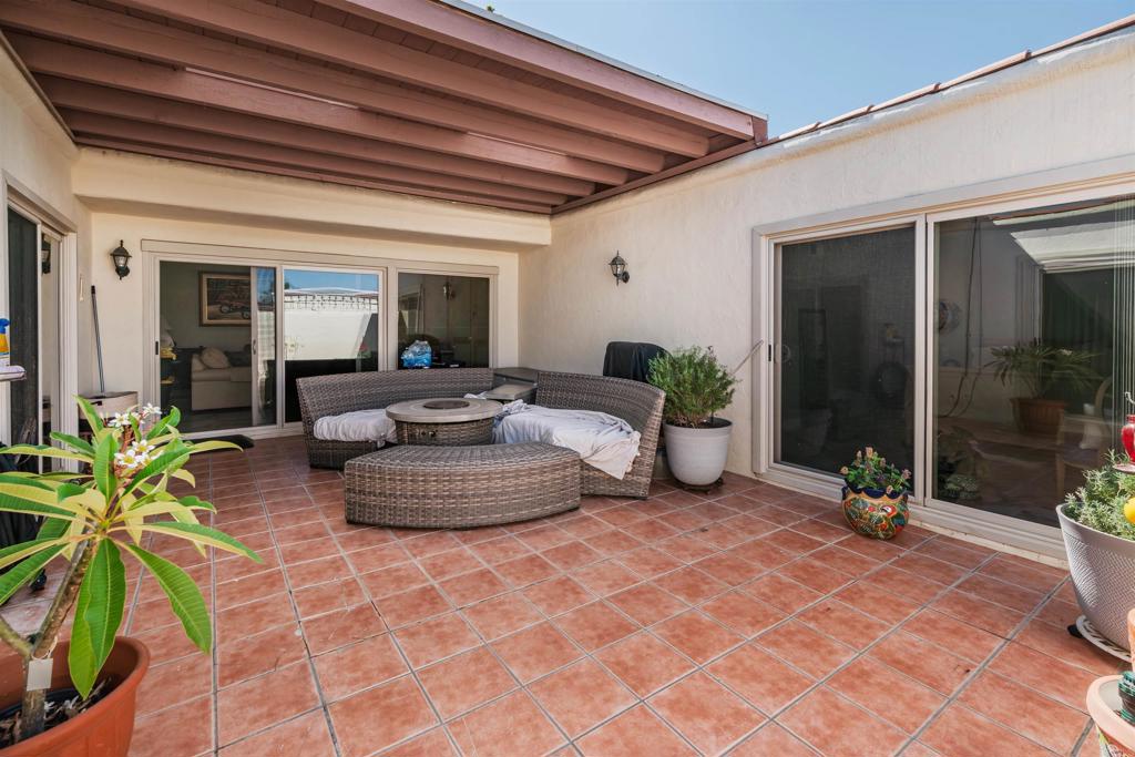 Welcome to a cheerful and stylish 2-bedroom, 2-bath home with a versatile office/optional 3rd bedroom in the heart of Oceana, Oceanside’s active 55+ community! Here you’ll find not only a comfortable retreat, but also a vibrant lifestyle with access to a sparkling pool, clubhouse, lush gardens, dog park, art and lapidary studios, woodworking shop, billiards room, pickleball courts, boat/RV parking, a fully equipped weight room, and the lush Emerald Isle Golf Course winding through the neighborhood. Step inside and discover a home designed for comfort, style, and easy living. Throughout the interior, honed ceramic tile flows seamlessly from room to room, complemented by fresh designer paint (2022), plantation shutters, updated vertical blinds, and energy-efficient double-paned windows and sliders. Ceiling fans in every room keep the spaces airy and inviting, while the office provides flexibility as a workspace, hobby room, or a possible guest bedroom. Each bedroom occupies its own quiet wing, offering direct courtyard access through sliding glass doors. The primary suite includes mirrored closet doors and a beautifully updated ensuite bath, while the guest bedroom is conveniently located near the second full bath and discreet laundry closet. The bathrooms shine with thoughtful upgrades—new cabinets, fixtures, and countertops—while the primary bath feels like a private spa with its marble shower and built-in teak bench. The kitchen is equally impressive, boasting a farmhouse sink, stylish new backsplash, refreshed countertops, and all-new appliances that make both cooking and entertaining a joy. At the heart of the home, a private atrium creates a true indoor/outdoor living experience, with every room enjoying direct access. Imagine morning coffee surrounded by greenery, tending to your herb garden, or dining al fresco under the stars in this serene and versatile space. Additional highlights include central air conditioning with a smart thermostat, an oversized one-car garage plus driveway parking, ample guest spaces, a roof updated in 2020, and even a front-row view of Oceanside’s Fourth of July fireworks—an annual celebration you can enjoy from the comfort of your own home. And when you’re ready to explore, you’ll find sandy beaches, golf courses, shopping, dining, and all the best of coastal living just minutes away. This home blends convenience and charm, making every day feel like a vacation.