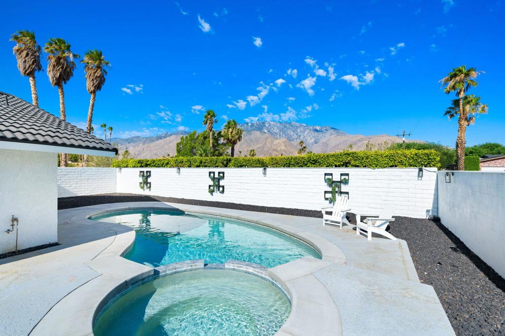 Enjoy stunning mountain views from the pool and spa at this beautifully renovated Palm Springs home. Offered turnkey furnished or unfurnished, it's well maintained and ready for you to move right in--just bring your toothbrush and start enjoying your oasis. The open kitchen with center island connects perfectly with guests, while the step-down living room with fireplace and French doors creates a warm indoor-outdoor flow. Each bedroom includes TV and linens, and the updated bathrooms are fresh and ready for use. The garage doubles as a bonus space with A/C, washer and dryer, and entertainment equipment. Outdoors, choose from a shaded patio or multiple sitting areas as you relax by the pool and spa with unforgettable views. Additional features include dual-paned windows, LED lighting, alarm system, and RV parking. With plenty of space for living and entertaining, this home checks all the boxes for making the most of the Palm Springs lifestyle.