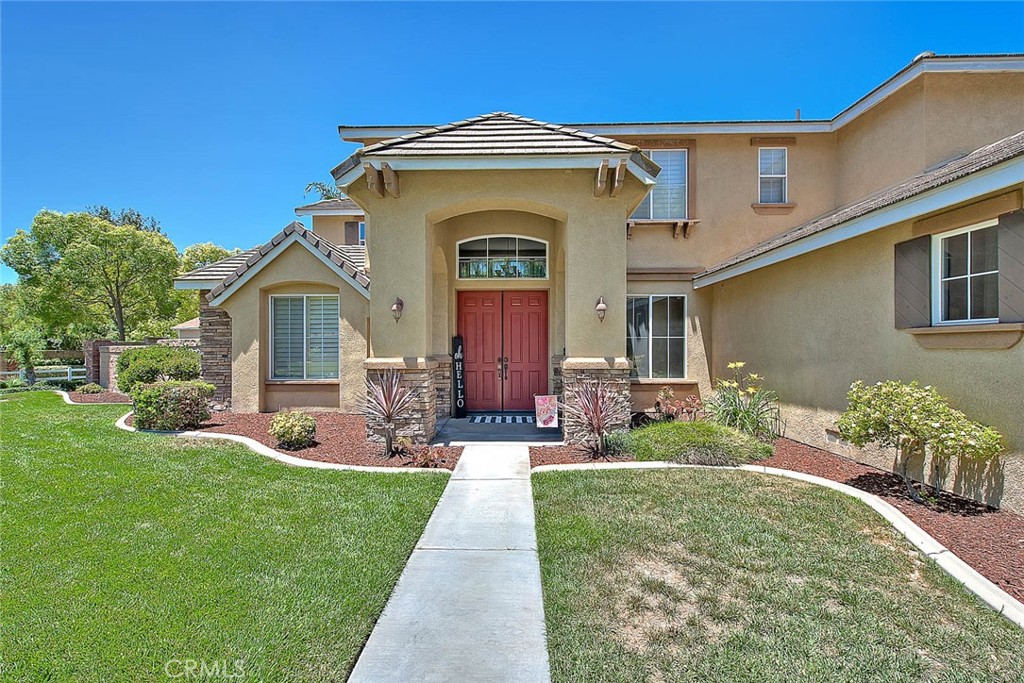 5 bedroom 4 1/2 bath pool home on a corner lot on nearly a half-acre lot. Enter into this stunning home through a grand open entry with soaring ceilings, setting the tone for spacious and elegant living. Kitchen is a butlers dream with an Island, breakfast bar, granite countertops, double oven, and a walk-in pantry. An adjacent breakfast nook offers a cozy space for meals, complete with ceiling fan and crown molding. Oversized family room off kitchen features a fireplace and built-in shelving, perfect for relaxing or entertaining. Large formal dining room for your family gatherings. Livingroom and game room offer is flooded with natural lighting. Downstairs bedroom with full bath, perfect for guests or multi-generational living. An additional 1/2 bath with decorative accent wall. Indoor laundry room offers wash sink and lots of linen storage. Upstairs offers 4 more bedrooms including the luxurious primary suite with decorative accent wall, ceiling fan, and fireplace. The primary bath includes a soaking tub, huge walk-in shower with dual shower heads, double sinks with additional vanity and an extra-large walk-in closet. Secondary bedrooms are good size all with ceiling fans. 2 additional full baths complete the upstairs. Shutters and custom window coverings enhance the comfort and style throughout. The home showcases beautiful, engineered wood flooring throughout with carpet in the bedrooms. Enjoy your resort-style living in your backyard oasis, complete with a beautiful rock waterfall pool and spa, and plenty of space for outdoor entertaining. Aluma wood patio cover. Additional features include 4-car attached garage, Large RV parking, Storage shed, and a spacious front yard with direct access to horse trails. This exceptional home offers luxury, function, and space-perfect for families, entertainers, and outdoor enthusiasts alike. A must see!