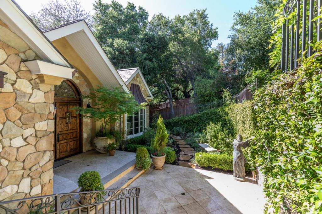 This stunning custom-built, French-inspired country estate is situated on nearly an acre lot on coveted University Ave. With 5,653 sf in main house and 800 sf in guest house for total of 6,453 sf, this magnificent estate has a total of 6 BD/5BA, and 2 powder rooms. There's tremendous flexibility throughout the living areas with 2 offices, theater room (or 5th bedroom in main house), conservatory, & playroom which is nestled among 3 additional upstairs bedrooms. Chefs will delight in the abundant amenities the kitchen offers, including 2 ovens, 2 dishwashers, Sub-Zero refrigerator, and warming & steaming drawers. The delightful 1 BD/1 BA guest house offers luxurious living and includes an open living room, dining area, fully-equipped kitchen, and private bedroom w/full bath. The resort-like yard provides the utmost in privacy and features lush grounds with pool/spa, outdoor kitchen, flat screen TV, fire pit, fireplace, and lighted sport court. Located near parks, shopping & dining.