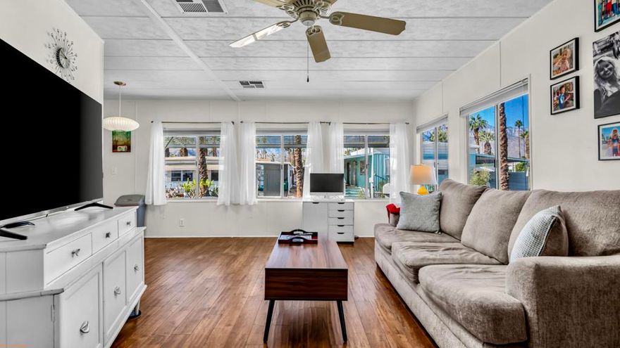 BEAUTIFUL 2BD/1BA manufactured home showcasing PRIDE OF OWNERSHIP with fresh, inviting aesthetic--inside and out in the desirable Royal Palms community--offering MODERN DESERT COMFORT with a CHARMING MID-CENTURY touch. Perfectly located in Cathedral City minutes from Palm Springs and Rancho Mirage with quick access to Hwy 111, this home provides convenience, style, and INCREDIBLE VIEWS.Step inside to a BRIGHT, ENCLOSED SUNROOM that FILLS the HOME WITH NATURAL LIGHT and opens into a SPACIOUS LIVING ROOM framed by STUNNING VIEWS of the SAN JACINTO MOUNTAINS. The dining area features a built-in buffet and pendant lighting, creating a warm and inviting space to entertain.The KITCHEN has been THOUGHTFULLY UPGRADED with BUTCHER BLOCK COUNTERTOPS, subway tile backsplash, gas cooktop, and newer refrigerator. A separate laundry area sits just off the kitchen for added convenience.The BATHROOM showcases a TASTEFUL REMODEL with UPDATED SINK AND COUNTERTOPS, a MARBLE-TILED SHOWER, and a bamboo feature wall for added texture and warmth. The primary bedroom offers generous space and a walk-in closet, while the guest room is perfect for visitors or a home office.Outside, the BACKYARD has been REFRESHED WITH GRAVEL, STONE PAVERS, FENCING and a charming gazebo--ideal for morning coffee, outdoor dining, or simply soaking in the breathtaking mountain views. The home is PARTIALLY FURNISHED and ready to add your personal finishesRoyal Palms offers resort-style amenities including a newly renovated fitness center, pool and spa, pickleball courts, BBQ area, RV storage, 3 parks for your furry friends,and more.