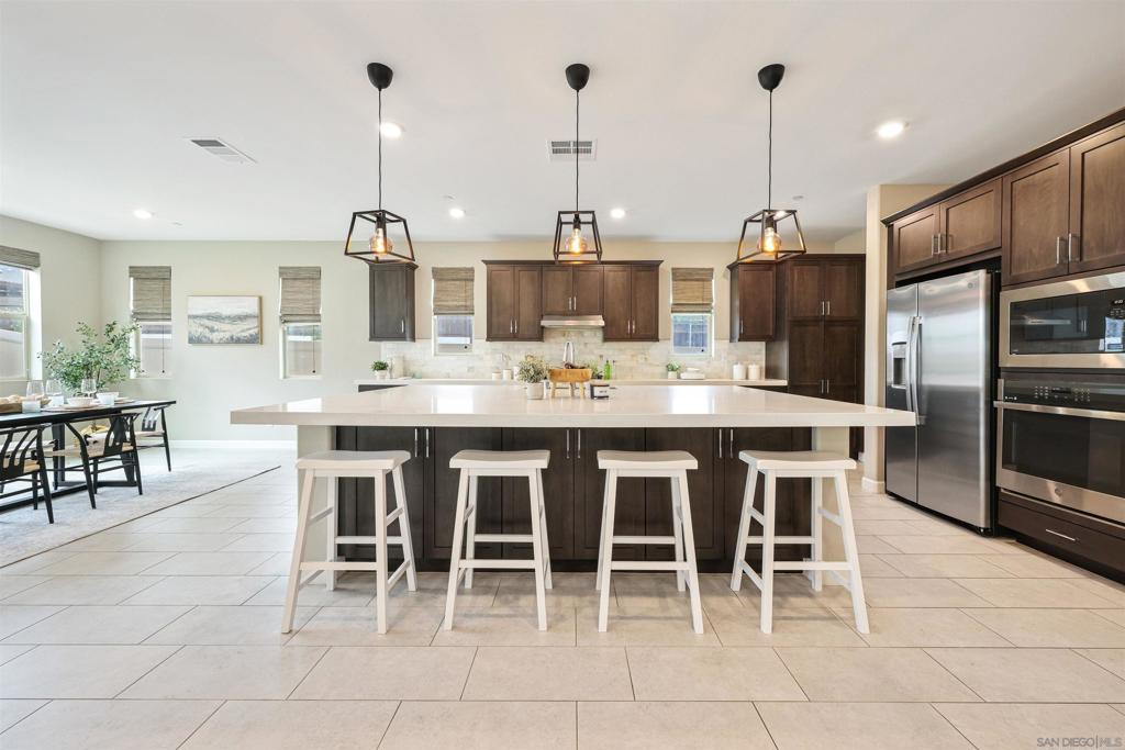 Beautiful 5-Bedroom Home on Private Cul-de-Sac, located in the desirable community of Canopy Grove. Built in 2021, this highly upgraded, Light and bright, 5-bedroom, 3.5-bath home with 3,209 sq ft of open living space, is nestled on a premium lot at the end of a quiet cul-de-sac. The spacious floor plan features a large kitchen island  with a breakfast bar, stainless steel appliances, and an abundance of natural light throughout. The open-concept layout features a downstairs bedroom and attached full bath,  making it ideal for guests or a home office. Upstairs offers a generous loft, perfect for a second living area, along with a spacious primary suite featuring a walk-in closet and spa-like en-suite bath.  Enjoy a beautifully landscaped outdoor space with a covered patio, ideal for entertaining or relaxing. Owned Solar panels provide energy efficiency.  Don't miss out on this gorgeous, move-in-ready home. Canopy Grove offers beautiful amenities, including miles of walking trails, a pool, spa, clubhouse,  multiple parks, dog park, volleyball, pickleball, and more.
