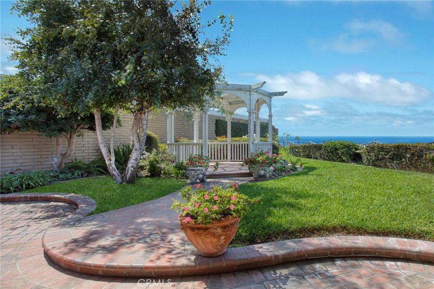 Located on the beachside of Coast Hwy in the 24-hour gated oceanfront community of Niguel Shores, this one-story "BEACH HOUSE" offers the ultimate coastal lifestyle. Perched on a premium cul-de-sac lot, with only 3 homes on this street, this property spotlights a lovely ocean and sunset view, a large front gated courtyard and large back yard with built in BBQ, lush landscape and just minutes to the sandy beach. With ocean views from all main rooms, this home has been expanded with a center fireplace surrounded by family, living and dining areas, an open kitchen concept complete with granite counters and stainless steel appliances, 3 Bedrooms, 2 Baths, large walk-in finished closets, an inside laundry area which leads to the 2-car attached Garage. The primary bedroom opens to the ocean view and garden patio and includes a built-in office work space.  Recessed lighting, vaulted ceilings, new paint and carpet, plus lovely brick patio areas highlight the charm of this seaside gem. The spacious back yard is ready for entertaining a crowd or just relaxing in the tranquil setting. Homes in this area and on this street are rarely available.  Niguel Shores includes an oceanfront blufftop park and parking lot with direct beach access and a wonderful Clubhouse with pool, spa, pickleball, tennis, sports courts, park and more. The community of Niguel Shores is situated next to the Ritz Carlton Hotel and is minutes close to the Marina at Dana Point, the Waldorf-Astoria Monarch Beach Resort, the Links Golf Course, and to the Art Colony of Laguna Beach. Enjoy the fun and festive beach lifestyle all year around in NIGUEL SHORES...The "Best-Kept" Secret Along The Coast!