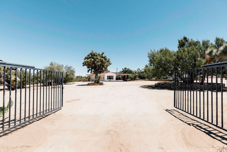 Welcome to a truly exceptional opportunity in the heart of Yucca Valley -- a 3-acre, fully fenced estate featuring two detached homes, a 2,500 sq ft barn, 6-stall stable, a 16' meditation yurt, and direct backyard access to Joshua Tree National Park. Tucked away just minutes from town with fully paved road access, this property blends privacy, versatility, and investment potential.The main residence offers 3 bedrooms and 2 bathrooms with updated laminate flooring and fresh interior paint. The detached guest house -- a fully rebuilt 1 bed, 1 bath casita -- is currently generating $25K-$30K annually in Airbnb income.Property highlights include:16' meditation yurt, designed for quiet reflection and personal enjoymentGrandfathered 2,500 sq ft barn and 6-stall stable -- perfect for a gym, studio, garage, or creative workspaceBuilt-in charcoal/wood BBQ -- great for outdoor cooking and entertaining$40,000 in recent improvements, including new exterior paint on all structures, refreshed landscaping, and resurfaced cement throughoutOwned solar system powering all buildings on the propertyLocated in a Designated Dark Sky Zone -- perfect for stargazingPrivate, oversized electric entry gate with multiple additional access pointsOccasional winter snowfall enhances the peaceful desert atmosphereWith no dirt roads, seamless access to the park, and a rare mix of character, flexibility, and income potential, this distinctive Yucca Valley retreat is a true lifestyle and investment opportunity.