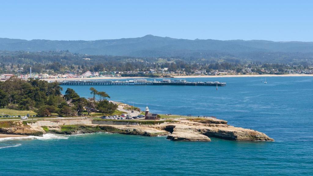 Living, Loving, Life...At the Beach Can't beat the location Westside Santa Cruz. Less than a mile from the ocean, and close to the scenic hiking trails of Wilder Ranch & Pogonip. Whether walking, biking, or unwinding by the coast, you'll be near vibrant downtown, renowned surf spots like Steamers Lane, & beautiful parks such as Lighthouse Field and Natural Bridges State Park. This place combines the best of historic charm with modern conveniences. 4BRs and 2.5 bathrooms spread over 1,923SF, it welcomes you with a cozy covered porch and a classic entryway featuring a Tiffany-style pendant light,transom window and a beautifully curved staircase. The first floor includes an expansive parlor (aka living room) with high ceilings, bay seating area, wainscotting, and gas fireplace.You'll be delighted with the spacious dining room, office nook, and updated kitchen equipped with stainless steel appliances and a breakfast bar. There are 2 generously sized bedrooms, 2 full bathrooms, and laundry area. Upstairs, there are 2 more bedrooms, a half bath, office, and bonus playroom with angled ceilings and distant views. Outside, enjoy a large patio & deck with both covered and sunlit spaces. Embrace the active life in this uniquely charming property, where adventure & relaxation meet.