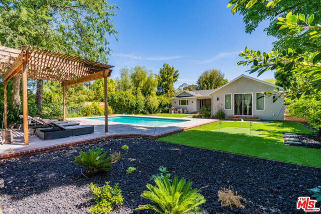 FULLY FURNISHED & EQUIPPED, AVAILABLE FOR SHORT-TERM RENTAL. Relax in this spacious 4-bed, 3-bath home in Woodland Hills with a private pool, cabana, and small golf course. The large kitchen is perfect for cooking, and the master suite boasts a luxurious bath. Enjoy outdoor entertaining with a BBQ area, bar stools, dining table, and lounge chairs on the covered deck. Close to restaurants, shopping, and easy access to the 101 Freeway. Perfect for relaxation and hosting!