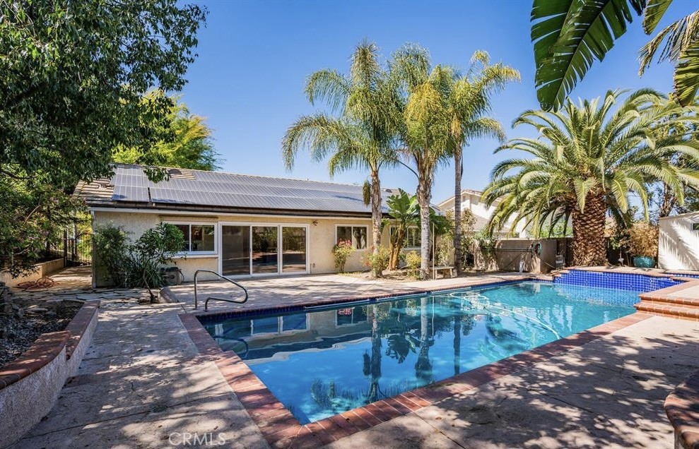Welcome to this beautifully remodeled Mid-Century Modern 4-bedroom, 2-bathroom home in the highly sought-after Lynn Estates neighborhood of Thousand Oaks. This single-story gem is a true retreat, offering a spacious and private backyard oasis with a sparkling pool and spa. Spanning over 1,800 square feet, the open and inviting interior features vaulted ceilings and ample natural light, creating a bright and airy feel. The updated kitchen includes solid surface countertops and stainless steel appliances, while the primary bedroom features a walk-in closet with organizers and a private ensuite bathroom. Beyond the home's interior, the expansive backyard provides plenty of space for outdoor enjoyment and relaxation. The home is equipped with solar panels, making way for lower energy bills. This fantastic property is available for rent furnished or unfurnished.