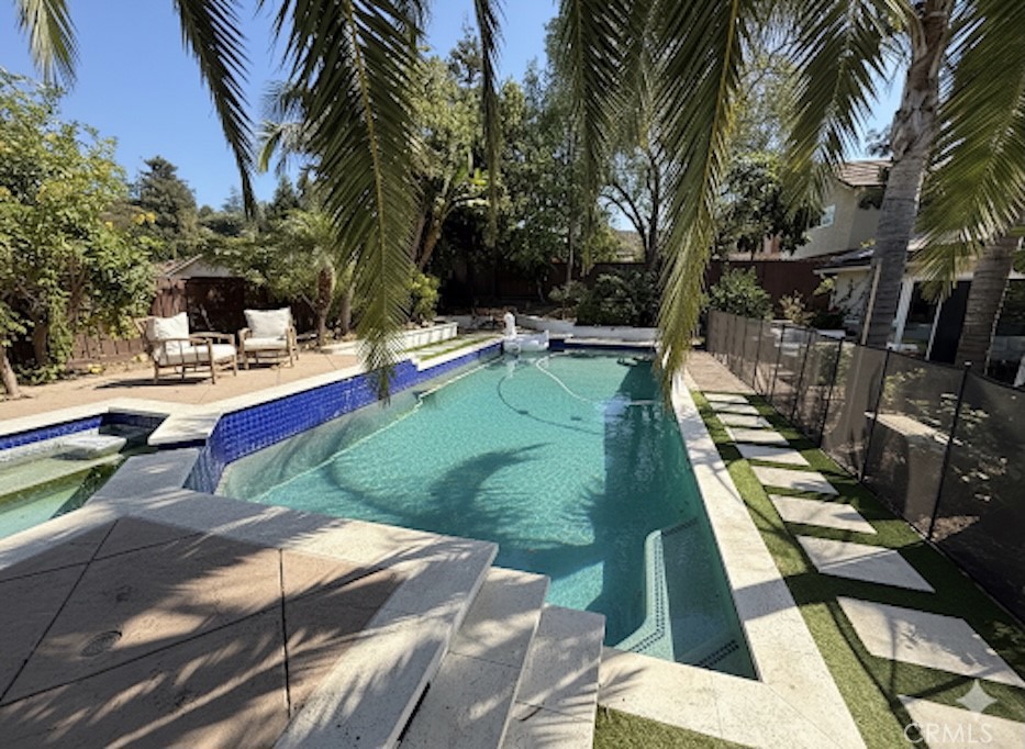 Welcome to this beautifully remodeled Mid-Century Modern 4-bedroom, 2-bathroom home in the highly sought-after Lynn Estates neighborhood of Thousand Oaks. This single-story gem is a true retreat, offering a spacious and private backyard oasis with a sparkling pool and spa. Spanning over 1,800 square feet, the open and inviting interior features vaulted ceilings and ample natural light, creating a bright and airy feel. The updated kitchen includes solid surface countertops and stainless steel appliances, while the primary bedroom features a walk-in closet with organizers and a private ensuite bathroom. Beyond the home's interior, the expansive backyard provides plenty of space for outdoor enjoyment and relaxation. The home is equipped with solar panels, making way for lower energy bills. This fantastic property is available for rent furnished or unfurnished.