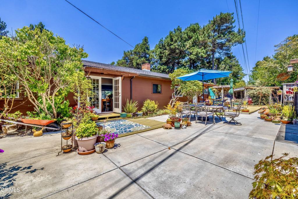 Experience the harmony of classic mid-century modern design and lush garden tranquility at 18841 Lahmon Lane. 3 bedroom, 2.25 bath home has had many upgrades including new dual paned windows, restored hardwood floors, low maintenance cement patios and a Cougar 5th wheel with utilities used as a guest house in the past. Mid-century modern interior details include a front door with unique heart-shaped window and original wood paneling accents in the living room. The brick fireplace has been upgraded to a convenient electric fuel source with a heatolator. There is also forced air heat. The vintage kitchen has a new oven with ceramic cooktop and a breakfast nook that captures morning sun. Beautifully remodeled bathroom off of the laundry room has a walk-in shower. Owner has removed walls in the living space to create an open-concept interior with many windows offering garden views from every angle. In the private backyard you'll find flourishing native plants, vibrant blooms and mature trees provide year-round color. There are multiple outdoor entertaining zones including a shaded pergola, Zen-inspired sitting areas and places to soak in the sun. Also included is a Peak 11,200 KVA generator. Come see this stylish vintage escape grounded in nature and nostalgia.