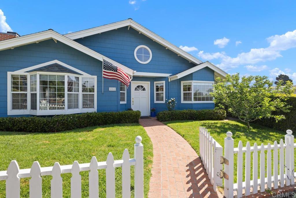 Fall in love at first sight with this beautiful single-level 4-bedroom, 2-bath home. A classic white picket fence and inviting brick walkway lead you into this delightful residence. Inside, you'll find gleaming hardwood floors, a soaring vaulted ceiling, and a cozy brick wood burning fireplace. Skylights throughout fill the home with natural light, creating a warm and welcoming atmosphere. The backyard is a true retreat, featuring multiple fruit trees (nectarine, avocado, banana, apple and plum), a lush grassy area, and a detached two-car garage with convenient paved alley access. Energy-efficient living is a bonus with solar panels and a Tesla Powerwall battery. Located just minutes from Sunset Cliffs, Ocean Beach, and the charming village of Point Loma—this is San Diego coastal living at its finest!