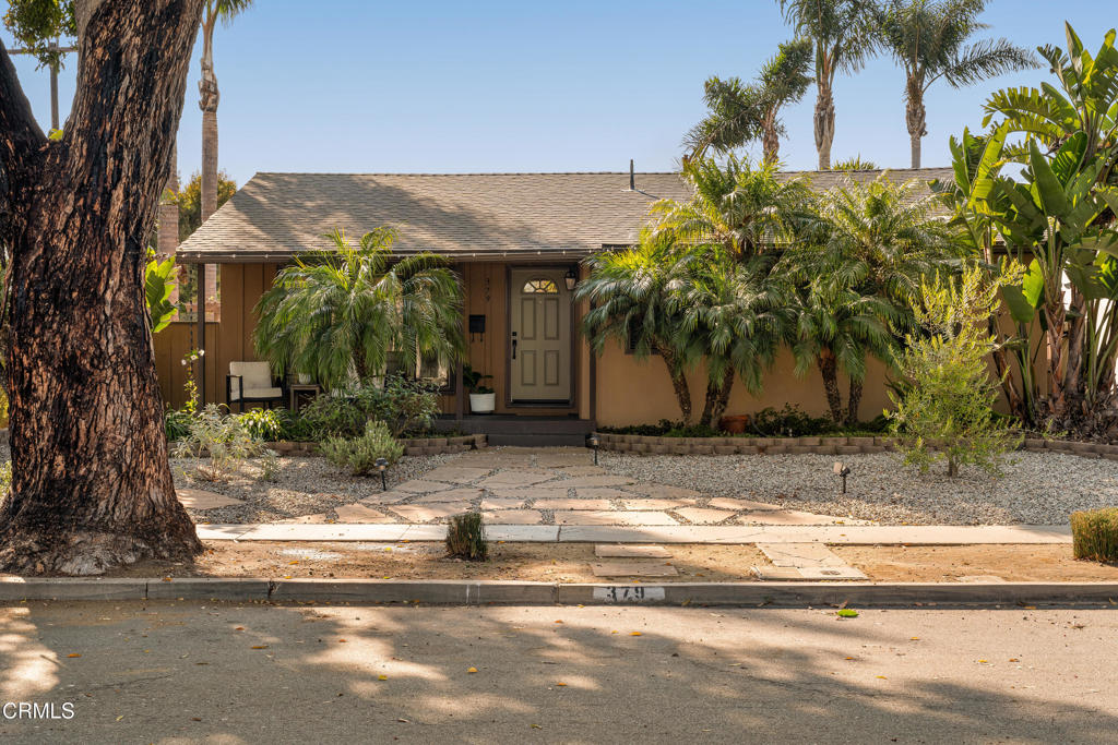 Midtown charm minutes from the beach.This 1950s ranch, nestled in the shade of mature trees, sits on one of Ventura's most desirable midtown streets. Three rooms, plus a flex space in the garage.The open kitchen-living room floor plan is ideal for entertaining and flows seamlessly to both the charming front sitting porch and the fully fenced, private backyard. Host a dinner on the back patio under string lights beside the outdoor fireplace, or start your day on the back deck with direct access from the primary bedroom. Thoughtful low-water landscaping provides privacy, while large front windows allow for excellent natural light. Another benefit of this quiet corner lot property, is the 2 off-street parking spaces.This rare 2-bathroom midtown gem is truly the perfect place to call home.