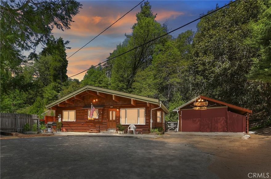 Meander up a tree-lined driveway, all the way to the top, there you will find a private cabin with lot's of mountain charm.  It is located in the town of Cedar Glen with quaint country stores, the famous Cedar Glenn Restaurant, Post Office and so much more.  On a large lot with plenty of privacy, lot's of hiking trails behind the home and so much history.  The lot has many trees, just a few to mention is the apple tree, apricot tree and a pear tree too!  The main house has two spacious bedrooms and one bath with laundry located in the bathroom closet., corian counter with beautiful rock work , a tile shower with the same beautiful rock work.  Open kitchen with farm size sink, corian counters, trash compactor, dishwasher, lot's of hickory (once know as pecan) wood cabinets and flooring.  The living room is open to the kitchen with a charming wood fireplace, beautiful wood beams with more quality woodwork throughout the cabin and plenty of windows to let the sunshine in.  There are two additional rooms across from the main house that were permitted as office and hobby room.  The garage is being used now as the seller's workshop originally built as a 1.5 car garage.  There is air condition and central heat in the main house for all the different seasons in the San Bernardino mountains.  The main house was rebuilt in June 2005 from the bare "studs up".  This is a special cabin you will want to call home and not want to leave!