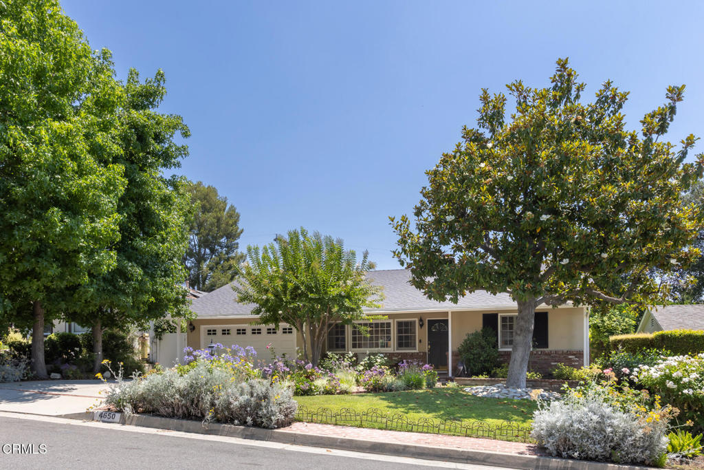 Nestled on a quiet street in the heart of La Canada Flintridge, this beautifully maintained single-level home offers three bedrooms, three bathrooms, and lush, mature landscaping that surrounds the property with privacy and charm. Step inside to a spacious living room with a cozy fireplace, seamlessly connected to a bright dining area, ideal for everyday living and special gatherings. The kitchen, equipped with stainless-steel, Viking appliances, opens to a comfortable family room, ideal for everyday living, and opens to a covered patio, creating the perfect indoor-outdoor flow for year-round entertaining. All three bedrooms are thoughtfully positioned in the south wing of the home, including a generous primary suite with walk-in closet, and direct backyard access. A separate laundry area and powder room are conveniently located just off the kitchen.The backyard is a private retreat with a grassy lawn, covered patio, and gated spa. Enjoy close proximity to La Canada Elementary School, Memorial Park, Foothill Blvd., and freeway access. Located within the highly acclaimed La Canada School District.