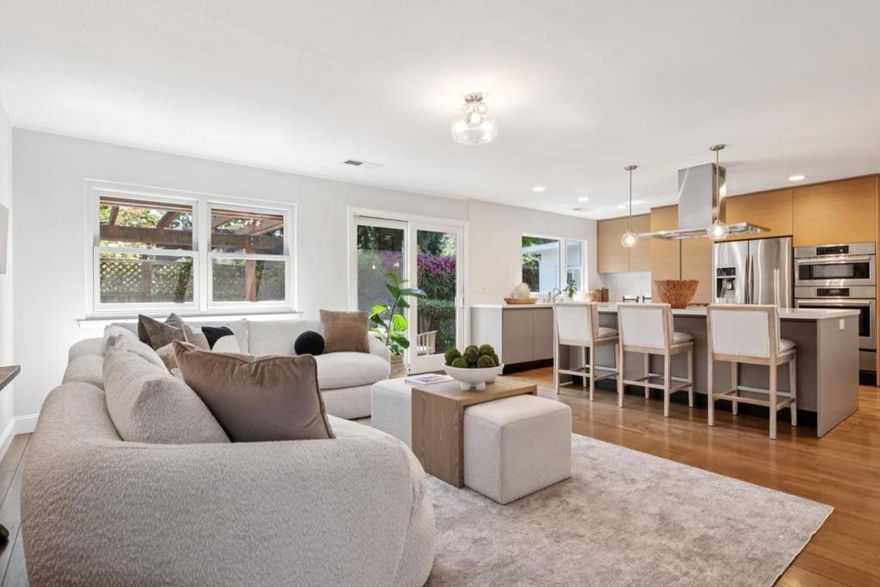 Situated on a desirable corner lot in Menlo Park's coveted Menlo Oaks neighborhood, this extensively updated residence blends modern style, everyday comfort and Silicon Valley convenience. A welcoming front porch leads to a light-filled living room with a cozy fireplace and expansive picture windows, while the adjacent dining area provides a seamless flow for both intimate dinners and larger gatherings. At the heart of the home, the remodeled kitchen-family great room is ideal for entertaining and daily living, featuring quartz countertops, a large center island with seating and top-tier stainless appliances including a Wolf cooktop, Bosch ovens and dishwasher, and a Samsung French-door refrigerator. The primary suite offers dual walk-in closets and a refreshed bath with dual sinks and a spacious shower. Two additional bedrooms share a remodeled hall bath, and a dedicated home office creates the perfect remote work setting. Outdoors, multiple al fresco dining and lounge areas unfold beneath a charming pergola amid mature landscaping. Energy-efficient features include solar power, 240V EV charger, tankless water heater and Andersen dual-pane windows. Close to top Menlo Park schools, Stanford, downtown Palo Alto, Meta and Hwy 101, this home offers modern living in a prime location.