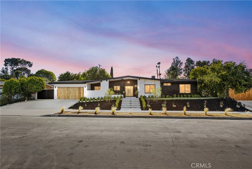 Nestled on a tranquil tree-lined Street, this masterfully restored, single-story Charles Dubois  home offers an unparalleled living experience. Located in one of the most highly desirable Woodland Hills neighborhoods of Woodland Hills , you'll enjoy close proximity to award-winning schools, exceptional shopping and entertainment at The Village, The Commons in Calabasas, and some of the best restaurants around. From the graceful entry adorned with mature trees to the alluring zen-like yard “with Mountain View’s “ this home embodies true California living. With an extensive high-end renovation in 2025, this residence has been carefully restored and transformed into a chic and stylish showstopper with Lots of Curb appeal , seamlessly blending Modern design with modern comforts. Upon entering, you are greeted with the interior Foyer living area featuring Open Spacious Floor plan and a cozy Art piece Mid Century Modern fireplace, and an amazing view of the lush front yard with its brand new, Remodeled pool and Lounge area perfect for year-round entertaining. The interior is thoughtfully arranged with open living and dining spaces in mind. The newly remodeled kitchen, complete with European-style custom wood cabinets and a stunning center island “ Chefs Kitchen” provides the perfect setting for entertaining. Adjacent to the kitchen is an expansive dining room with a fireplace, large windows, and sliding doors that lead to the breathtaking backyard oasis. This home also features a large family room and Custom Wine room area holding up to 52 bottle creating an ideal space for casual gatherings. The Living and Dining rooms open directly to the backyard, enhancing the indoor-outdoor flow. In the backyard, you'll find a custom-built Large Patio with a dining area inside, perfect for alfresco meals. The backyard also boasts a Large freshly laid Sod Grassy yard with ample space for relaxation or entertaining. There are four bedrooms with on suites for each bedroom including the primary suite, which features an exquisite bath, custom tiles and a custom built walk-in His/ Hers closets and and Sliding door that open to the Pool & Lounge area and enjoy a great view of the gorgeous pool & Mountains views Tranquil and very private backyard with custom barbecue and entertainment area. Don’t miss your Chance to make it yours!