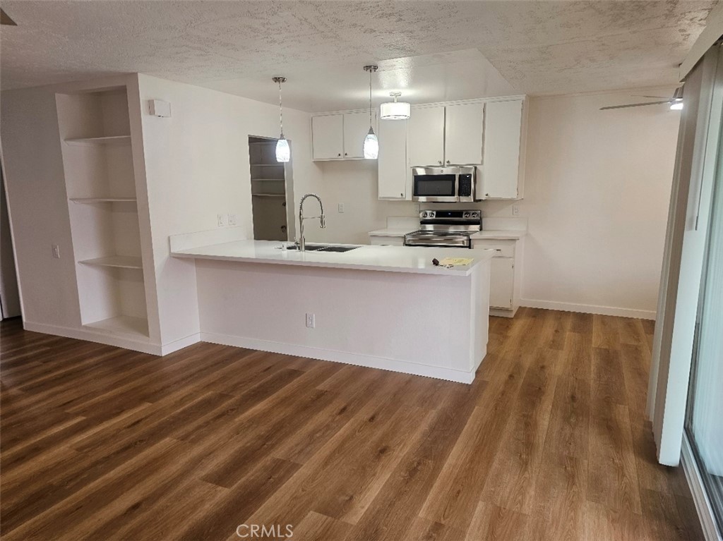 Completely remodeled! This is your chance to rent a beautifully remodeled top end unit! No one is above or below you. Brand new mini split air conditioning, With a unit in the living room and each bedroom. The kitchen is beautiful with a huge quartz counter. Great for food prep or use for meals. New appliances, and washer dryer hook ups. All the floors are brand new, with vinyl throughout most of the home, and carpet in the bedrooms. 4 new ceiling fans. One in the living room, one in the dining area, and one in each bedroom. New paint throughout. Completely remodeled bathroom. A new vinyl sliding door that leads to a patio overlooking the pool. This unit also has a 1-car garage PLUS 1 assigned parking space for added convenience. The association pool and spa are just steps away. This unit is move-in ready. Close to freeways, shopping and entertainment. This is a must see!