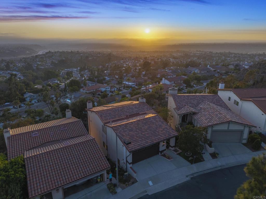Super rare unobstructed panoramic multi-million-dollar view! Every evening here can go like this… your family together on the private patio, kids laughing, the sky painted with a beautiful panoramic sunset, and the ocean shimmering in the distance on a clear evening. Wake up each day in one of San Diego’s most sought-after neighborhoods with an amazing school district, where peace of mind meets picture-perfect living. This three-bedroom, three-bath home sits in zone outside of California’s brushfire map, making it insurable and an investment for your family’s future. From the moment you step onto the patio, you are surrounded by panoramic views of the ocean, canyons, city lights, and even planes landing in the distance. On clear evenings, enjoy fireworks from SeaWorld and unforgettable sunsets as your children play nearby. Inside, the thoughtful floor plan is designed for both togetherness and privacy. The oversized master suite offers space to create a fourth bedroom if your family grows, while still leaving room for a relaxing retreat. The spa-inspired master bath invites you to unwind with a candlelit soak, and three full bathrooms mean no one waits during busy mornings. Storage is abundant, from the beautiful walk-in master closet to built-in cabinets and a large room downstairs perfect for seasonal décor, sports gear, or hobbies. The warm, inviting living areas flow seamlessly, making it easy to host family gatherings or spend quiet nights by the fireplace. Families will appreciate the award-winning school district, where your children can thrive academically and socially, and the tight-knit community where neighbors lend a hand and look out for one another. This is more than a home. It is a private, welcoming haven where sunsets, laughter, and lifelong memories are part of everyday life.