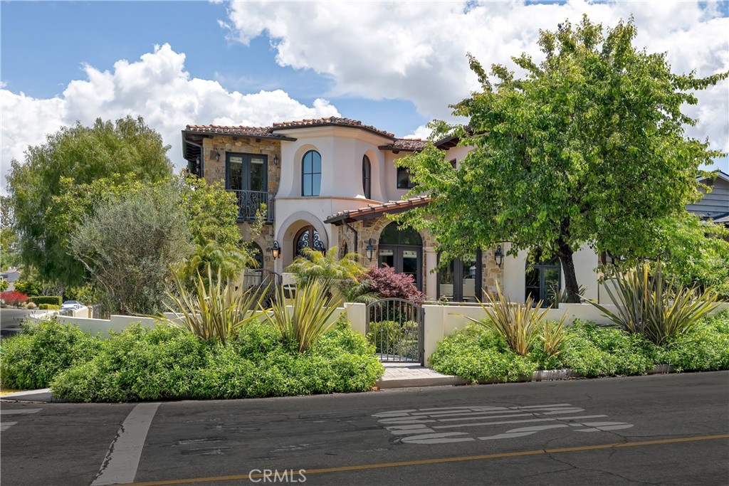 Step into timeless California elegance with this stunning Montecito-style villa, perfectly positioned on a corner lot in the prestigious Hill Section of Manhattan Beach. Spanning approximately 5,800 square feet, this custom residence offers 6 bedrooms, 5.5 bathrooms, an executive office, game room, home theater, and a temperature-controlled wine room.
From the moment you enter, rich architectural details set the tone—soaring ceilings, alder wood coffered accents, and a limestone fireplace anchor the formal living room. The chef’s kitchen features Viking appliances, custom cabinetry, and beveled granite countertops, opening to a sunny breakfast nook and expansive family room.
Designed for seamless indoor-outdoor living, oversized glass doors lead to a covered loggia with fireplace, built-in BBQ, and lush, private landscaping. A full outdoor bath and generous yard space make the home ideal for entertaining, play, or relaxation.
The expansive primary suite includes a spa-like bath and walk-in closet, while each secondary bedroom enjoys its own private balcony or patio via French doors. A 3-car garage with built-in storage and a workshop area adds function to the elegant form.
Experience the best of Manhattan Beach living—close to downtown MB shops, restaurants, top-rated schools, and the sand—all from this prime Hill Section home.