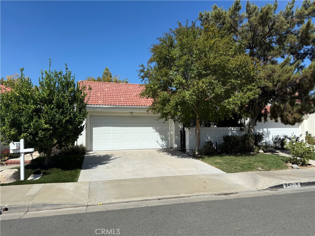 This charming single-story home is tucked away in the Valencia Summit - one of the most desirable neighborhoods, offering the perfect blend of comfort, style, and convenience. Inside, you’ll find beautiful wood flooring complemented by a bright interior. The home features 2 bedrooms plus a versatile office/den that can easily be converted into a 3rd bedroom to fit your needs. Large windows with wood plantation shutters fill the home with natural light while providing timeless style and privacy. Step outside to enjoy the home’s private courtyard and front patio—ideal spaces for morning coffee or evening relaxation. The backyard retreat features a paved walkway, a flourishing orange tree, and plenty of room to create your own landscaped paradise or weekend gardening oasis. Located in the prestigious Valencia Summit community, you’ll love the miles of paseos, scenic trails, and proximity to shopping, dining, and award-winning schools. No Mello Roos and low HOA includes Pool, Spa, Tennis Courts and so much more. Don’t miss your opportunity to own a beautifully maintained home in one of Valencia’s most treasured neighborhoods!