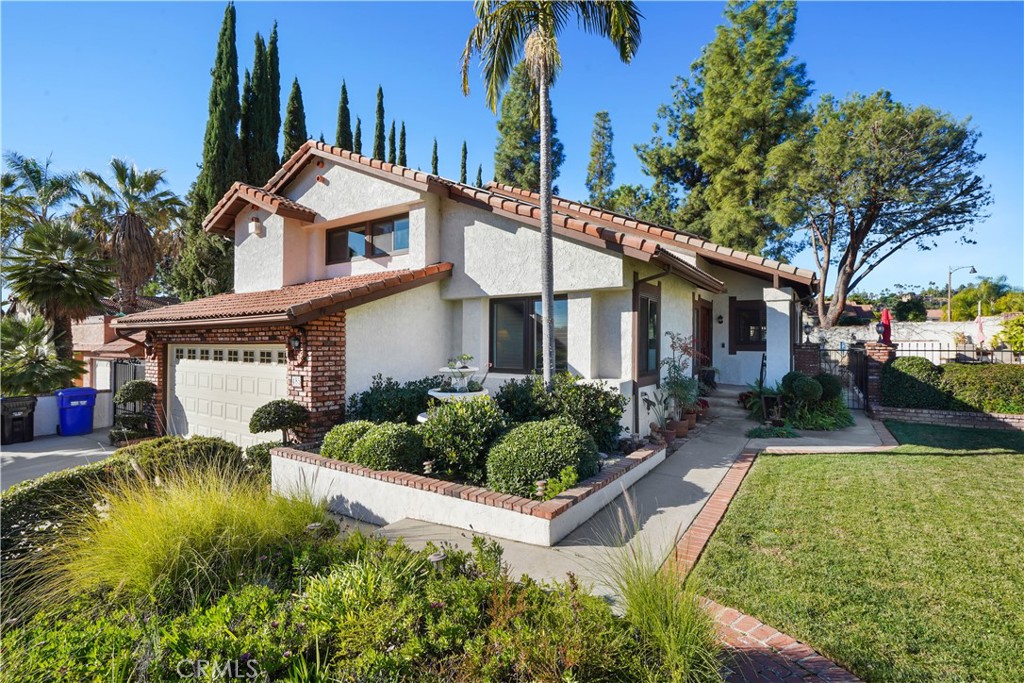 Tucked away on a peaceful cul-de-sac in desirable Upper Duarte, this stunning tri-level residence offers breathtaking mountain views and the perfect blend of style, comfort, and functionality.
Inside, you’ll find 4 spacious bedrooms, 3 full bathrooms, plus a versatile bonus room—ideal for a home office, guest suite, or playroom. The primary suite is a private retreat, complete with a custom-built walk-in closet and a spa-inspired bathroom featuring dual sinks and beautifully tiled shower accents. Generous closets can be found in every bedroom, ensuring ample storage.
The main family room is warm and inviting, highlighted by an updated fireplace and soft overhead accent lighting. An additional entertainment space on the lower level offers built-in reading benches with storage, custom shelving, and its own ambient lighting—perfect for movie nights, a library, or a game room. This level also features a bedroom and bathroom, making it ideal for guests or multi-generational living.
The Tuscan-style kitchen is a chef’s delight, boasting stainless steel appliances, granite countertops, and direct access to the backyard. Step outside and discover an entertainer’s paradise—complete with a built-in BBQ, outdoor kitchen, and beautifully landscaped grounds. Sliding doors connect the family room to the yard, creating effortless indoor-outdoor flow for summer gatherings. The sparkling gated pool and spa are accompanied by a custom lounge area where you can relax and take in the manicured surroundings.
Practical features add to the home’s appeal, including solar panels for energy efficiency, a whole-home battery backup for uninterrupted power, and an electric car charger in the garage, making it as sustainable and future-ready as it is luxurious.
This home is more than just a place to live—it’s a place to create lasting memories, host unforgettable gatherings, and enjoy the very best of Southern California living.