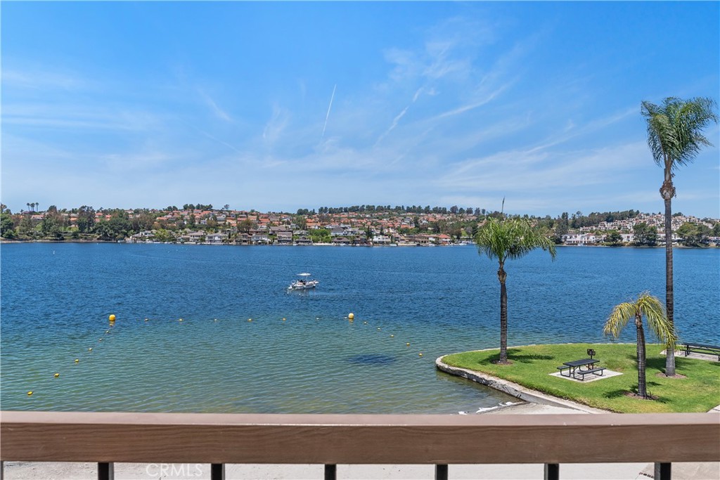 LUXURY DESIGNER MODEL PERFECT PENTHOUSE CONDO WITH BIG WATER SWEEPING LAKE VIEWS!! This absolutely gorgeous, totally remodeled with quality designer finishes and fixtures lakefront two bedroom condo on Lake Mission Viejo has an unobstructed, panoramic Lake view. The open floor plan boasts a top of the line chef's kitchen with large center island, large living room, formal dining room a master suite with walk-in closet and second bedroom and guest bathroom. Sweeping lakefront big water views from almost every room! The remodeled custom kitchen has been beautifully remodeled with beautiful counter-tops, high-end custom cabinetry, backslash, and high grade appliances. An entertainer's dream come true! Both bathrooms are completely remodeled with stone counter tops and custom fixtures. Entertain in the large living room with fireplace and blue, blue, blue water views as you sit and enjoy the lake! The property includes one single car garage and one covered carport, new central heat and air, fireplace and much more! Also has a gated front patio and gated rear patio with door which opens to the lakefront. Finisterra on the Lake is a gated lakefront community with private beach, pool, greenbelts, fishing dock, boat slips and drydock boat parking. Enjoy all that Lake Mission Viejo has to offer including private beaches, boat rentals, summertime concerts, holiday events and the grand Fourth of July fireworks display!