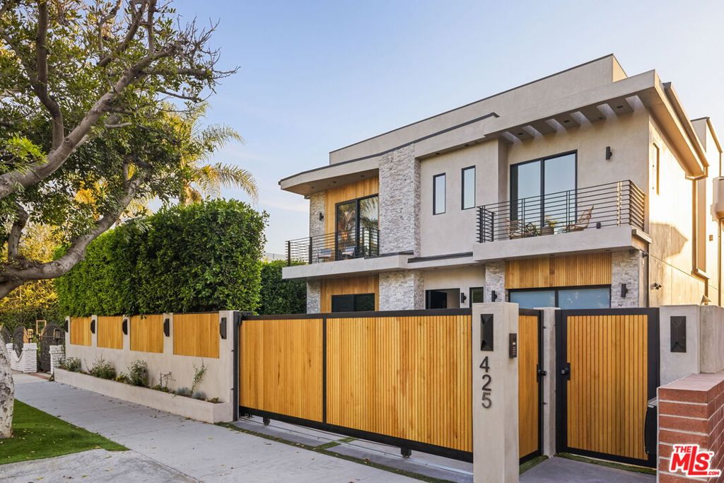 Welcome to 425 N Alfred Street a striking, custom-built residence in one of Los Angeles' most sought-after neighborhoods. This architectural gem offers over 5,200 square feet of thoughtfully designed living space, boasting 6 bedrooms, 4 full baths, and 2 half baths. Crafted with a steel structure frame, the home delivers an open-concept floor plan accentuated by soaring ceilings and an abundance of natural light from expansive windows and seamless pocket glass doors that create effortless indoor/outdoor flow. Set behind secure gates and surrounded by privacy walls, this property includes a separate 2-bedroom, 2-bath guesthouse with its own address perfect as a home office, guest retreat, or income property. Both the main house and guesthouse feature their own private garages, as well as rooftop decks with spas for luxurious relaxation under the stars. The backyard is an entertainer's dream with a pool, spa, outdoor shower, BBQ island, and a stylish covered cabana. Inside, refined details abound exquisite Italian doors with hidden hinges, magnetic latches, and smooth, modern finishes throughout. The main level includes a floating staircase, formal dining room, and a media room ideal for gatherings. The gourmet kitchen is a chef's delight, highlighted by a skylight and high-end appliances. Upstairs, the light-filled bedrooms offer serene escapes, including a glass-wrapped suite with privacy shades. The primary suite impresses with its own private deck, pocket doors, walk-in closet, and a spa-like bathroom featuring a soaking tub, glass stone shower with built-in bench, rain shower system, and massage jets. Ideally located near LA's premier shopping, dining, and entertainment minutes from Melrose Avenue, The Grove, Beverly Center, and the vibrant heart of West Hollywood this one-of-a-kind estate blends elegance, comfort, and world-class design.
