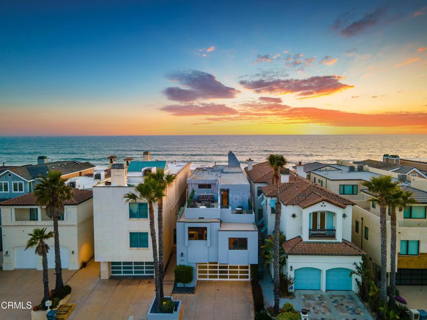 Welcome to your dream Beachfront house, perfectly nestled on the sands of beautiful Mandalay Beach. This gem is situated on a semi-private street, west of the main beachfront road, ensuring less car and foot traffic for a peaceful, beachy vibe.   Positioned on a west-facing beach, the house offers breathtaking sunsets every evening. Enjoy panoramic 180-degree views of the ocean, islands, whitewater, and coastline, stretching across the Santa Barbara channel to the Channel Islands and the Ventura coastal foothills.  Step into the gourmet kitchen, a chef's paradise, featuring a center island, a 48-inch Viking cooktop, a Viking double oven, and a built-in Subzero refrigerator. The first level dazzles with a wall of windows that open fully to a spacious deck, providing direct access to the sand and creating an inviting indoor-outdoor living experience.  The family room exudes coastal charm with high vaulted beamed ceilings and a cozy fireplace. This level also offers three bedrooms and three baths, along with a den off the kitchen that could serve as an optional sixth bedroom.   The second level is dedicated to a generous primary suite, featuring a fireplace and a private deck. The primary bathroom is a sanctuary with a jetted tub, steam shower, fireplace, and, of course, stunning ocean views.    For an unforgettable evening, head to the rooftop deck to marvel at the starry skies, making it the perfect spot to entertain and relax while savoring the refreshing ocean air.The home boasts 3-zone radiant heating and a rare 6-car garage, ensuring comfort and ample space.  This Beachfront beauty offers an unparalleled coastal living experience with spectacular vistas and serene surroundings. Don't miss your chance to own this slice of paradise!