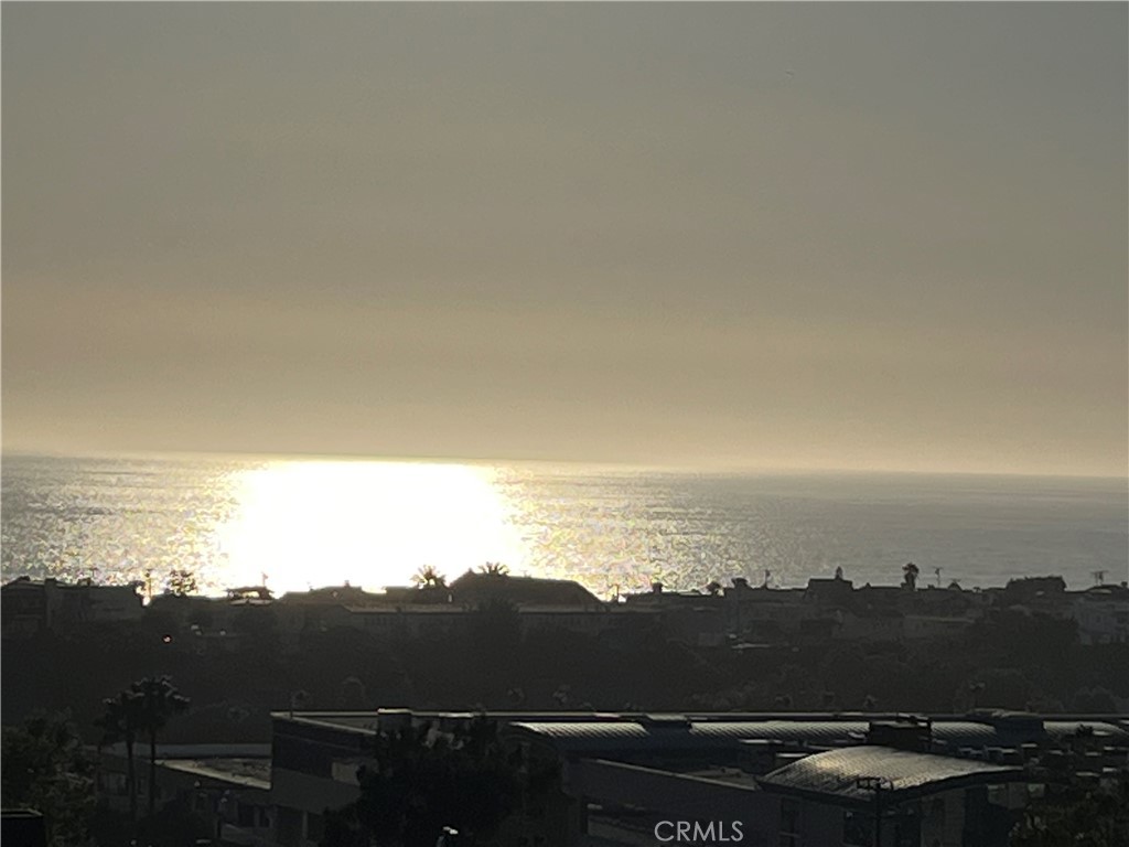 Panoramic ocean view newer freestanding townhouse in Hermosa Hill. This coastal plantation style home has four bedrooms and five bathrooms, with approximately 3300 sft. Gourmet kitchen that includes Viking appliances, a spacious large island, custom made cabinetry with designer finishes, and a giant 17' long sliding door that opens up to a grand patio, perfect for indoor/outdoor lounging and dining. While the ocean view from the patio is sublime, the jaw dropping views from the large roof top deck are breathtaking. Retreating to the primary suite, you will find abundant natural light, open space, high ceilings, and a luxurious en-suite bath and two additional en-suite bedrooms on the same floor. The fourth private en-suite bedroom on the lower level is an ideal office, gym and or guest quarters. A large two car garage with epoxied floors and ample storage, as well as a custom laundry room with plenty of cabinet space. Other features include a Pelican whole house soft water system, Ring video door bell, alarm system, and Sonos amp with ceiling speakers.