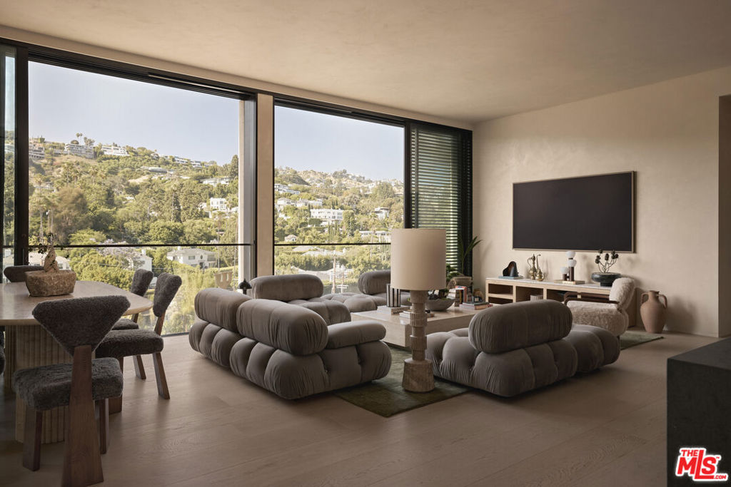 Offered fully furnished with brand-new, ultra-luxury designer pieces, this residence at The West Hollywood Edition combines turnkey convenience with impeccable taste. Designed by internationally acclaimed architect John Pawson, the 2-bedroom, 2.5-bath home spans approximately 1,856 square feet and features floor-to-ceiling windows framing panoramic views of the Hollywood Hills. The Molteni kitchen is outfitted with teak cabinetry, basaltina stone countertops, a Wolf range, and Miele appliances. The primary suite includes a custom walk-in closet and a spa-like bath with a floating double vanity and freestanding stone tub. Both bedrooms are equipped with CitiQuiet windows for enhanced sound insulation.Residents enjoy access to a private lobby, 24-hour security and concierge, valet parking, fitness center, spa, dining by Jean-Georges, and an exclusive rooftop venue.