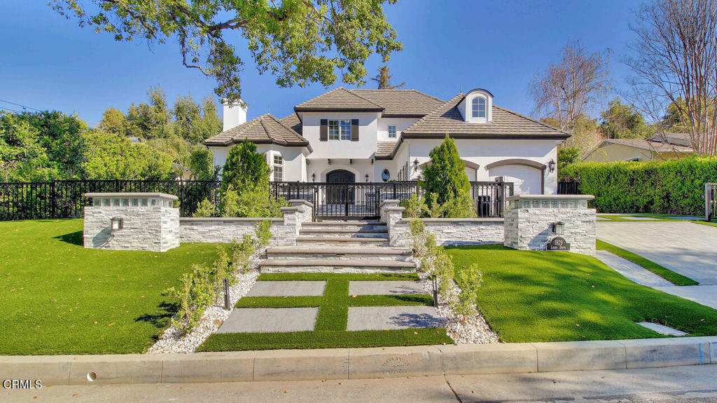 Welcome to 1929 Lyans where timeless design meets modern comfort in the heart of La Canada. This spacious 5-bedroom, 6-bath residence spans approximately 5,041 sq ft and features soaring ceilings, an open-concept kitchen, and expansive living and dining areas filled with natural light all through out within all around quiet, serene living. Enjoy seamless indoor-outdoor flow with a gated front yard full of space for numerous cars and RV's, with the back yard outfitted with an immense modern infinity pool, ideal for cozy evenings and year-round entertaining. Large bedrooms offer suite-like baths and generous closet space. Additional highlights include a massive entertainment level for music, billiards, table games, and movie nights. Enjoy comfort and tranquility for years and decades. Located minutes from top tier schools, shopping and dining and easy access to just about everything. This rare offering combines size, style, and unbeatable location. Come see the 1929 Lyans today.