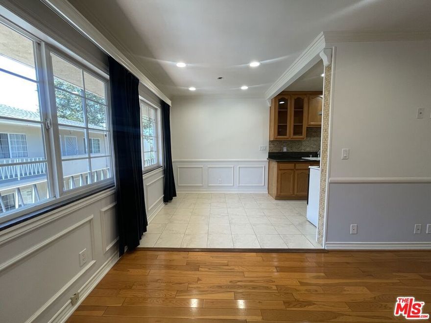 Discover charming West Hollywood living in this spacious upper-level 1-bedroom, 1-bathroom apartment. Located in a well-maintained 8-unit building, this unit provides a peaceful retreat while placing you just moments from the best shops, cafes, and everyday conveniences the neighborhood is known for. Inside, the unit features real hardwood flooring, elegant crown moulding, and beautiful wainscoting throughout, creating a warm and refined atmosphere. The generous living area flows into a well-appointed kitchen and dining area, equipped with stainless steel appliances, including a refrigerator and range with hood, plus a microwave and garbage disposal. The bedroom includes a large cedar-lined closet and an air-conditioning unit for personalized comfort. The bathroom is clean, bright, and updated with contemporary fixtures. Water and trash are included in the rent. One parking space is available for an additional fee. With a Walk Score of 95, this prime location places you moments from Trader Joe's, Sprouts, Target, Starbucks, and the countless dining and entertainment options West Hollywood has to offer. Easy access to public transportation makes commuting throughout Los Angeles simple and convenient.