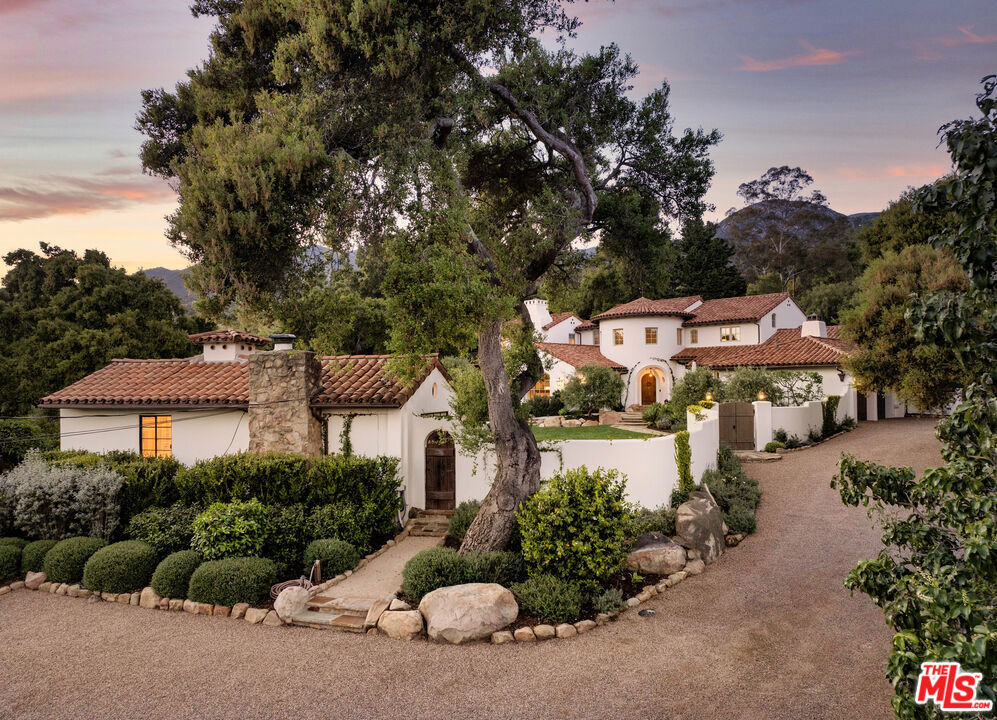 In the verdant splendor of Montecito, a reimagined Spanish Colonial estate offers a retreat from the everyday while embodying the essence of a luxury getaway. Unified by the soothing soundtrack of nature, the open design, 4 bd/4 ba home is joined by a 2bd/1ba GH, sparkling pool & Japanese soaking tub all blending seamlessly w the outdoors on a dramatic & lushly landscaped acre of fruit trees, oaks & olives & presiding over magnificent views of the mountains & natural surroundings. At the center of this well designed residence, the dramatic LR is complemented by the chef's kitchen, great room, DR, guest suite, gym/office & media room on the ground floor. Upstairs the primary suite is a sanctuary w peeks of the ocean joined by two add'l bds offering privacy & comfort. Sunny & stylish in SB.