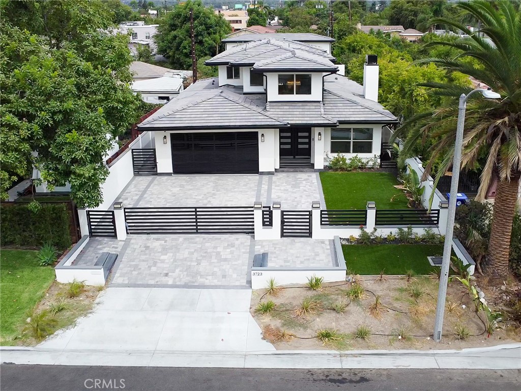 Brand-new construction in the desirable Michelinda Park neighborhood of East Pasadena featuring a spacious main residence plus a rare two-story detached ADU.
The main house offers approx. 3,500 sqft with 4 bedrooms and 5 bathrooms. The first floor includes a convenient guest bedroom, a private suite with its own full bath, and an additional powder room—perfect for visitors or multi-generational living. A dramatic double-height foyer with a modern chandelier opens to the light-filled living room with fireplace and the open dining area. The gourmet kitchen showcases an oversized island, quartz countertops, custom cabinetry, and premium stainless-steel appliances, ideal for both daily living and entertaining. Upstairs, the luxurious primary suite features a spa-inspired bathroom, walk-in closet, and access to an expansive private balcony with stunning views of the mountains and lush greenery.
The newly built two-story ADU provides approx. 1,200 sqft with 3 bedrooms and 3 bathrooms, a full kitchen, living area, and its own private entrance—ideal for extended family, guests, or attractive rental income.
Additional highlights include a 3-car garage, designer finishes throughout, and a large yard with artificial turf for low-maintenance landscaping. Conveniently located near Santa Anita Mall, Santa Anita Race Track, parks, and with easy access to the 210 Freeway.
