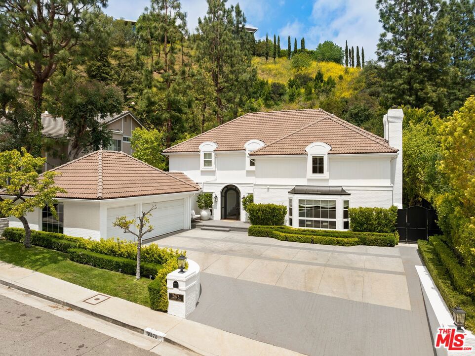 Discreetly located in a quiet cul-de-sac in one of Benedict Canyon's most coveted pockets, this elegantly reimagined home strikes the perfect balance of charm, space, and style. A dramatic entry and sweeping staircase set the tone, with sun-drenched interiors and a smart, flowing floor plan designed for easy living and effortless entertaining. The formal living, dining, and family rooms are generous and inviting, while the eat-in kitchen anchors the home with both beauty and function. Downstairs also features a private maid's suite, full laundry, and direct access to a spacious 3-car garage. Upstairs, the expansive primary retreat offers dual walk-ins and his n hers baths, with three additional bedrooms- one ensuite, one Jack-and-Jill for flexibility. Out back, the vibe is pure SoCal Leisure with a sparkling pool, large lawn and multiple lounge areas for relaxing or hosting under the stars. All utilities included. Short term lease available only until August 31st