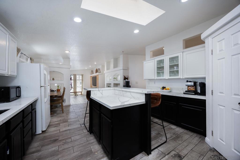 This updated 4-bedroom, 2-bath, 1,680 sq ft mobile home is located in the highly sought-after Lamp Lighter Village, an all-ages, dog-friendly community. It features a custom-built entertainment center, a generous living room, and recently upgraded floors and countertops. The home also includes in unit laundry and a remodeled bathroom with his and hers sinks for added comfort. A 2-car carport offers convenient parking. Residents enjoy access to fantastic amenities including a pool, gym, and clubhouse—ideal for relaxation or staying active. With easy access to freeway 54, this well-maintained home offers unbeatable space and value in a welcoming community. Don’t miss out!