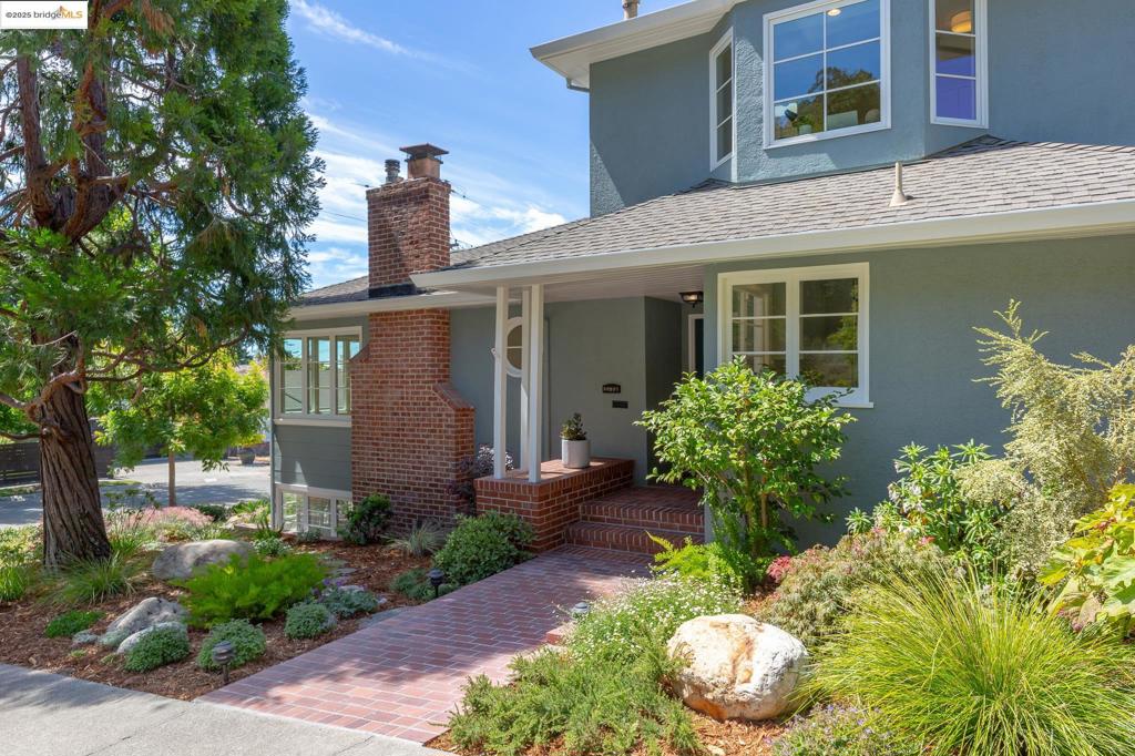 Just beyond the charming Woodminster business district—with its beloved bakery, restaurants,, and local shops—this spacious Traditional home rests on a sunny corner lot in a serene and established neighborhood. On the market for the first time in 30+ years, it has been lovingly maintained and thoughtfully expanded. A brick walkway meanders through mature, drought-tolerant landscaping. Step inside to discover elegant public rooms framed by classic archways and random plank hardwood floors. The living room features a gas fireplace and the adjacent dining room opens to the landscaped yard for seamless indoor/outdoor entertaining. Chef's will delight in the updated kitchen offering a peninsula-style layout with a Wolf 4-burner cooktop, Dacor double ovens & SubZero refrigerator. A carefully designed 2004 expansion added a second story with a sunlit primary suite complete with 3 closets and a spa-like bath as well as another bedroom or office and laundry. 2 bedrooms are on the main floor with a full bath and downstairs, a large family room/fifth bedroom awaits with a fireplace and walk-in closet. There's a full bath and direct access to the garage with 2nd laundry and a Tesla powerwall. The beautifully landscaped grounds are a dream for the urban gardener and the level lawn for play.