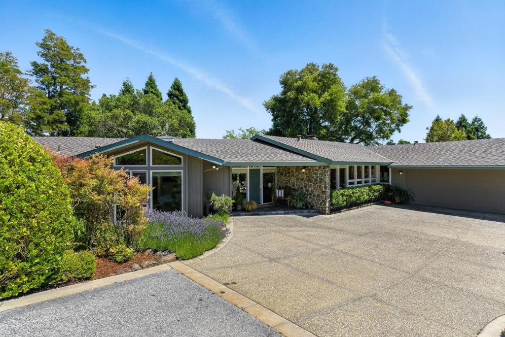 Welcome to your serene retreat in the heart of the Carolands. This exceptional one-level light-filled home offers a spacious living experience of 3,630 SF nestled on a 22,500 SF lot boasting a private wing of 4 bedrooms (2 en suites) & 4 full bathrooms. A gracious entry opens to an inviting living room with a grand fireplace capped with a copper hood & light-filling windows that frame the private rear garden with its majestic trees. The kitchen offers newer SS appliances, ample cabinetry, breakfast nook & desk area. Just off the kitchen is a laundry room with a fantastic pantry & easy access to an oversized two-car garage. The gracious dining room accommodates intimate gatherings or grand celebrations. Exceptional primary suite with high ceiling, walls of windows, large walk-in closet & private bath. The spectacular family room boasts a dramatic beamed ceiling, fireplace, walls of custom cabinetry, a wet bar, & windows that beckon one outdoors. A convenient bath for guests is nearby. An extensive outdoor patio for entertainment, plus a generous flat lawn area. Extra exterior storage. 2-Car + additional parking. Near top-rated Hillsborough schools, vibrant downtown Burlingame, and easy access to 280, 92, and SFO. Spectacular, easy living - the essence of the California lifestyle.