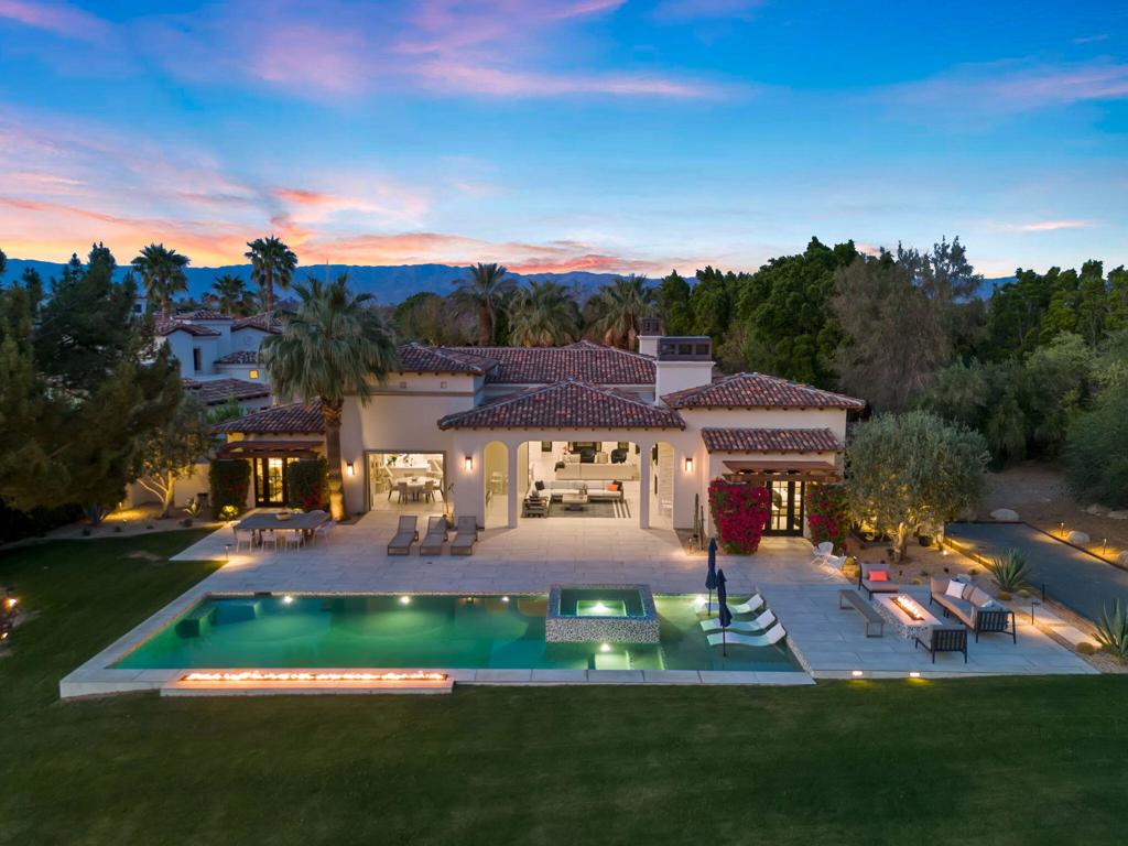 Welcome to one of the most remarkable properties in the prestigious Hideaway community of South La Quinta. Perhaps one of the largest and most private residences in the entire community, this 20K sq ft lot expands into acres of unobstructed southwest facing mountain views. With no other homes in sight from the interior view, this residence provides what is unparalleled privacy that is unique and will remain forever. The property has been transformed by the current owners over the last 12 years, expanding the initial lot through a land purchase from the club in 2014 and then subsequent work over the years has resulted in what can only be described as exposing a previous diamond in the rough. Positioned on the 16th hole of the Clive Clark course, this home is perfectly positioned at the end of a rare single lined cul-de-sac. This 5-bedroom, 5 1/2-bathroom residence all on one floor, features dual master suites, a fully enclosed courtyard entry that sets the tone for the refined living within. The interior showcases timeless architectural details including arched doorways and a modern wood coffered ceiling in the great room. A recent complete re-model blends classic Hideaway style with a modern flare, the result is a true turnkey opportunity for those looking for something special. Wall-to-wall pocket doors seamlessly connect indoor and outdoor living, leading to a sprawling covered patio with a built-in outdoor grill, firepit, and fireplace. The resort-style backyard is a true desert paradise, featuring a 40 ft pool with an elevated spa and baja shelf that leads to a perfect setting with a special view. The updated rear of the property is accentuated with fire features both at the pool's edge and an elevated outdoor entertaining area with firepit. Adjacent to the firepit is your own lighted bocce ball court. The property has a professionally designed outdoor sound system encompassing buried subwoofers and 16 speakers for an unparalleled and private listening experience. 53731 Via Mallorca, a rare and refined offering in one of the desert's most exclusive enclaves--this is Hideaway living at its finest.